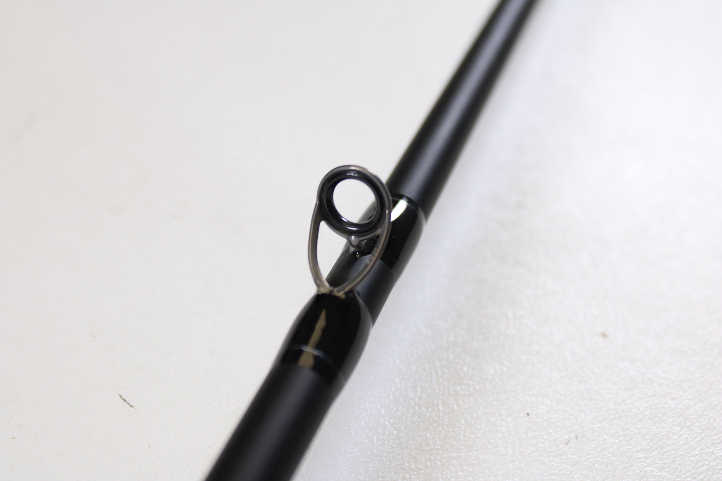Close-up of a Dobyns Champion XP DC705CBGLASS 7'0" Medium Heavy Glass Used Casting Rod in excellent condition, showcasing its line guide—ideal for anglers seeking quality pre-owned gear from Dobyns.