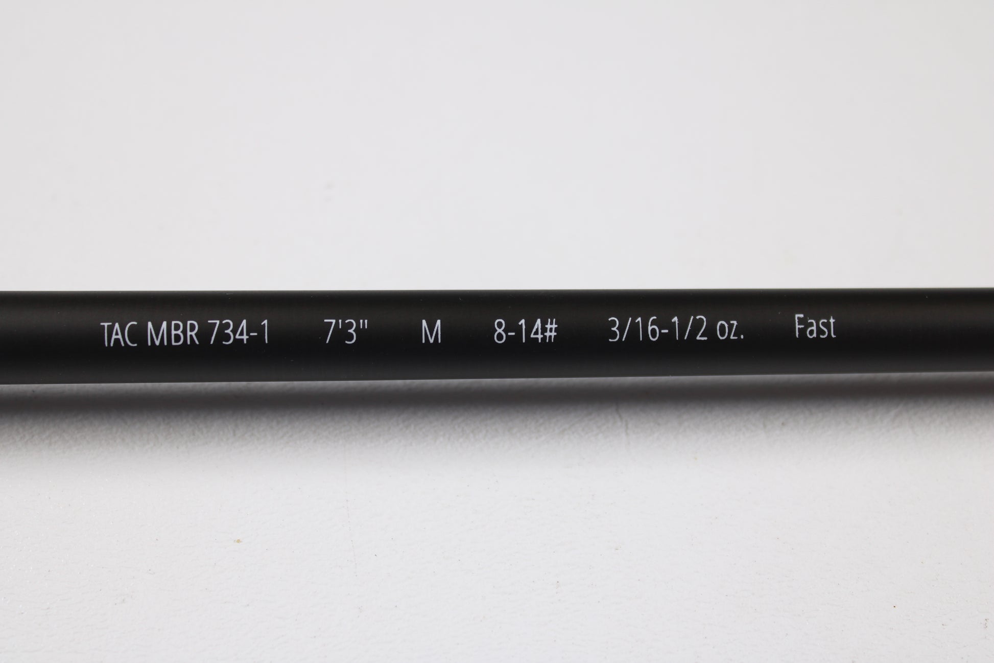 A close-up of the Temple Fork TFO Tactical Bass TACMBR734-1 7'3" Medium Used Casting Rod in excellent condition. Perfect for our rod and reel trade-in—swap your used gear for store credit. Shown on a plain white background.