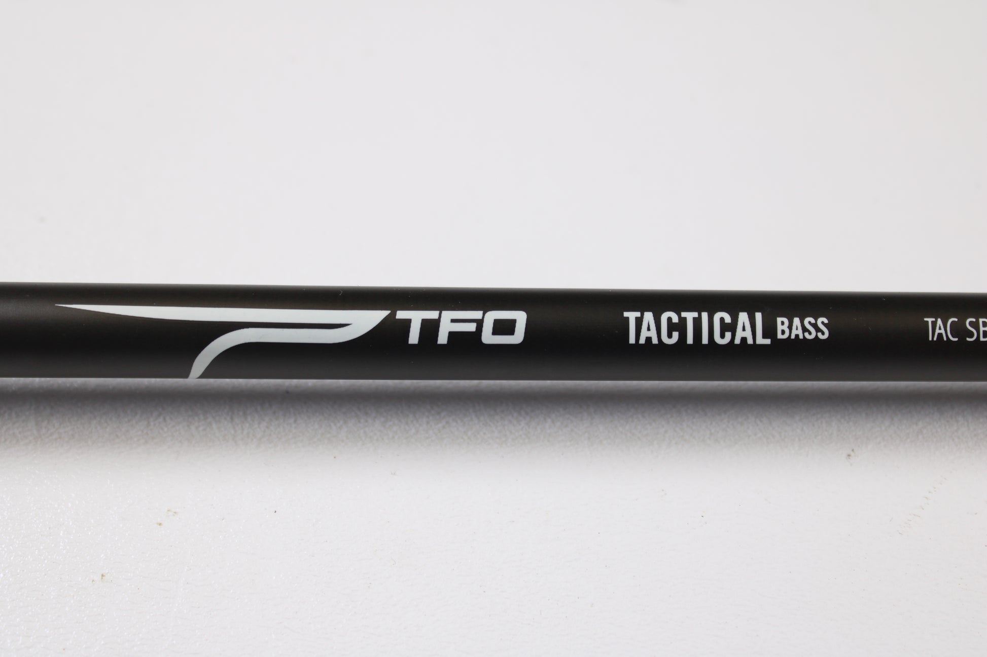 Close-up of a Temple Fork TFO Tactical Bass TACSB726-1 7'2" Heavy used casting rod in excellent condition, ideal for maximizing store credit through our rod and reel trade-in program, shown against a white background.