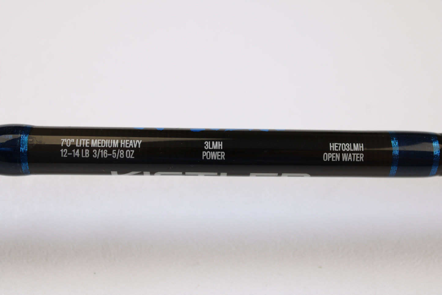 A close-up of a Kistler Helium HE703LMH 7’0” Lite Medium Heavy Used Casting Rod, in excellent condition, part of our Rod and Reel Trade-In Program. “12-14 LB, 3/16-5/8 OZ, 3LMH POWER” specs and blue accents are visible on this quality Kistler gear.