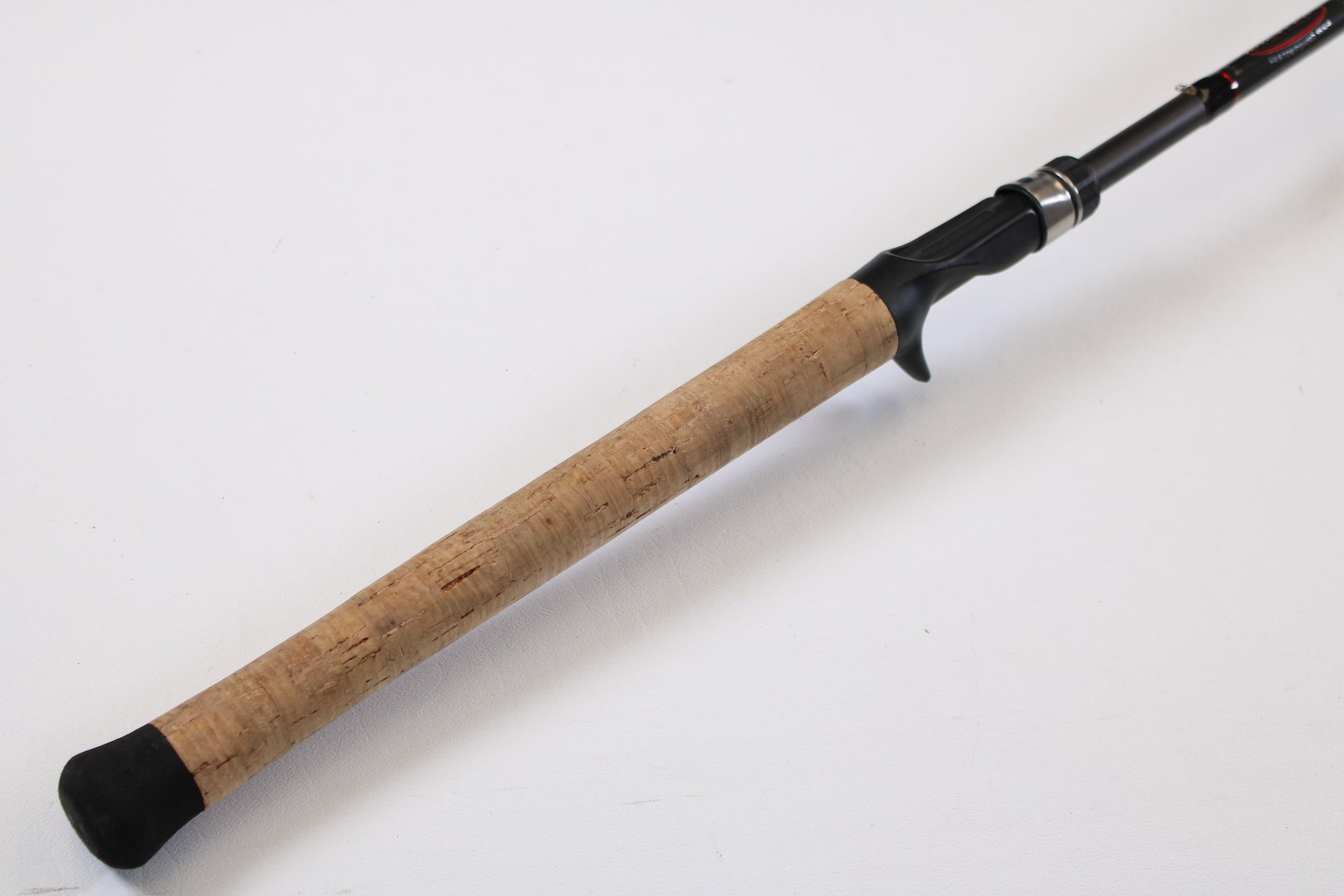 A close-up of the Kistler KFGS73 Frog and Slop Special 7'3" Heavy Used Casting Rod handle—featuring a cork grip and black reel seat—ideal for customers interested in our Rod and Reel Trade-In Program for store credit.