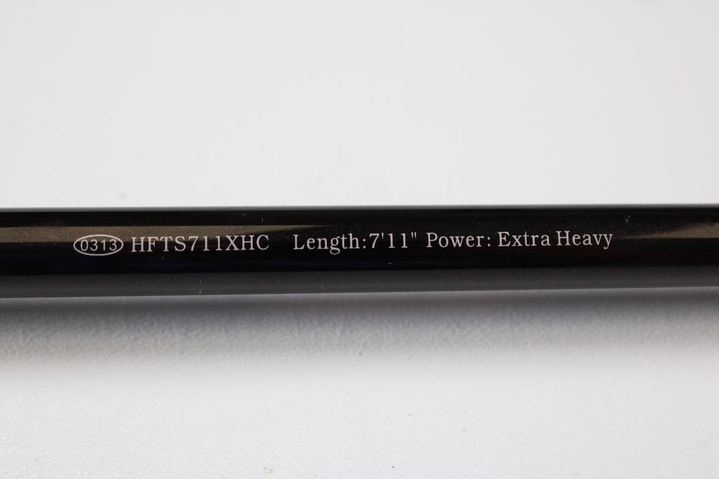A close-up of the Halo Twilite HFTS711XHC 7'11" Extra Heavy Used Casting Rod in excellent condition shows white text on a black rod and an oval marked 0313—ideal for our rod and reel trade-in program.