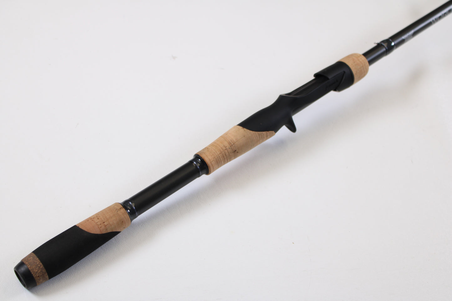 A close-up of the Fenwick World Class Bass WLDB75H-XFC 7'5" Heavy Casting Rod—Used, Excellent Condition—on a white background, ideal for our trade-in program where your used gear earns valuable store credit.