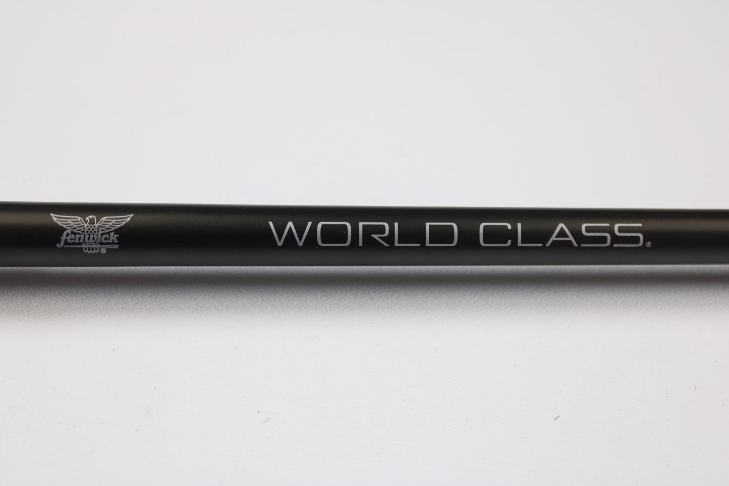 A close-up of the Fenwick World Class Bass WLDB75H-XFC 7'5" Heavy Used Casting Rod in excellent condition, showing the "WORLD CLASS." and small Fenwick logo—ideal for those trading in rods or seeking store credit on used gear.