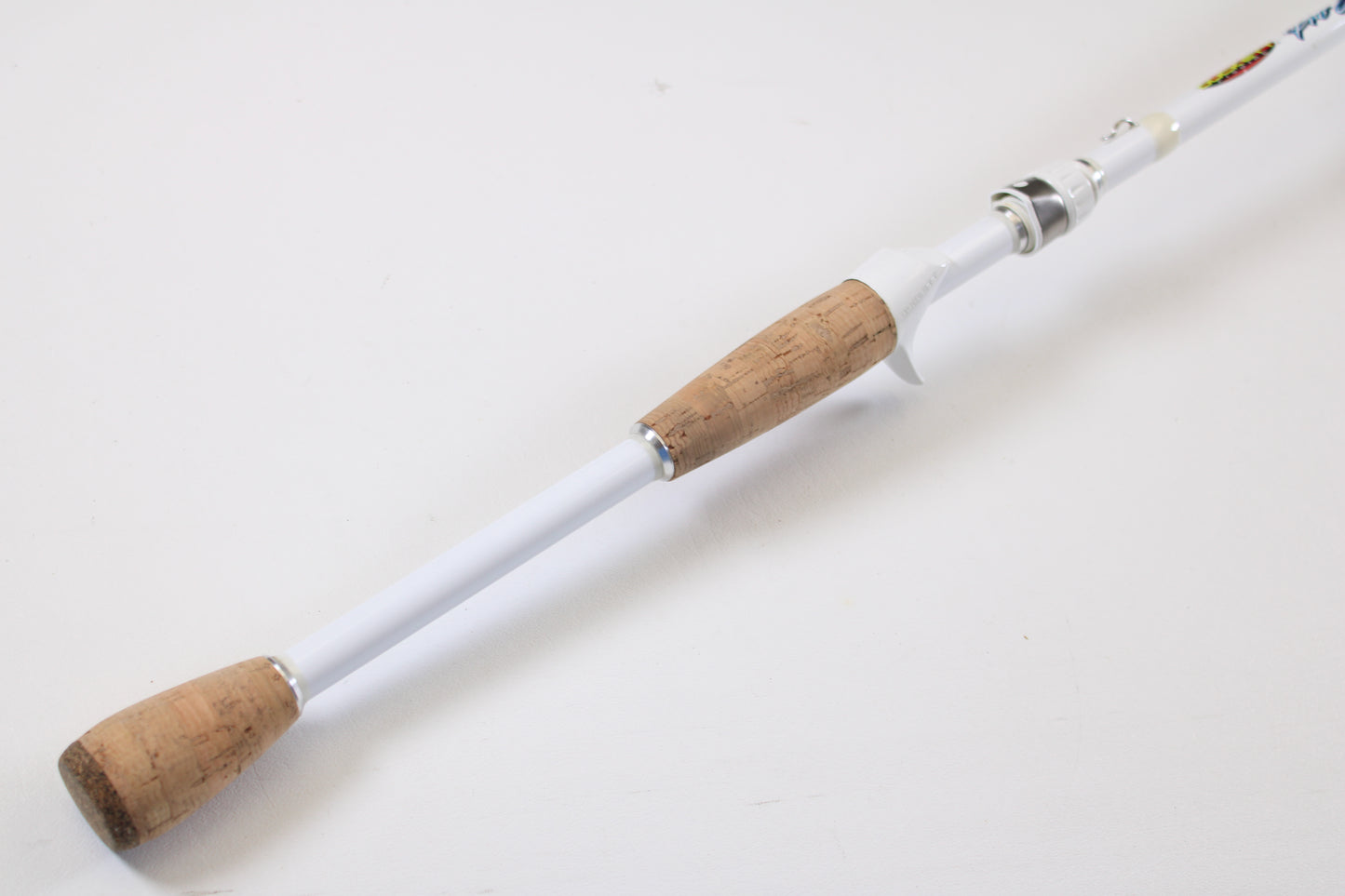 A close-up of the Duckett Pro Series DFPS74H-C Chris Lane 7'4" Heavy Used Casting Rod in excellent condition, featuring cork handles on both ends. Great for value seekers—trade in your rod or reel for store credit!.