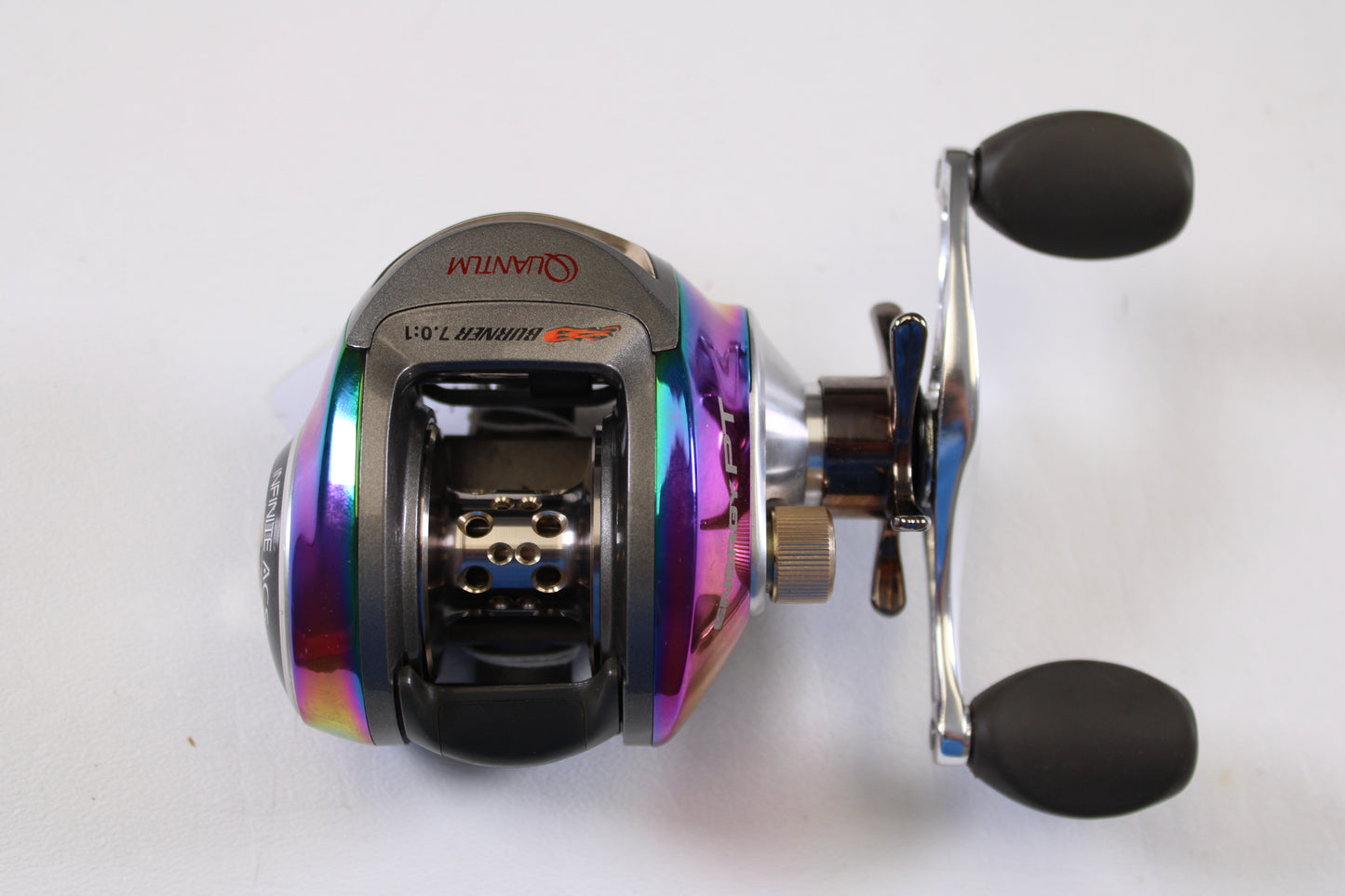 A close-up of the Quantum Energy PT E770PT 7.0:1 RH used casting reel in very good condition, featuring black handles and metallic accents—a great choice for the Rod and Reel Trade-In Program or enhancing your Quantum collection.