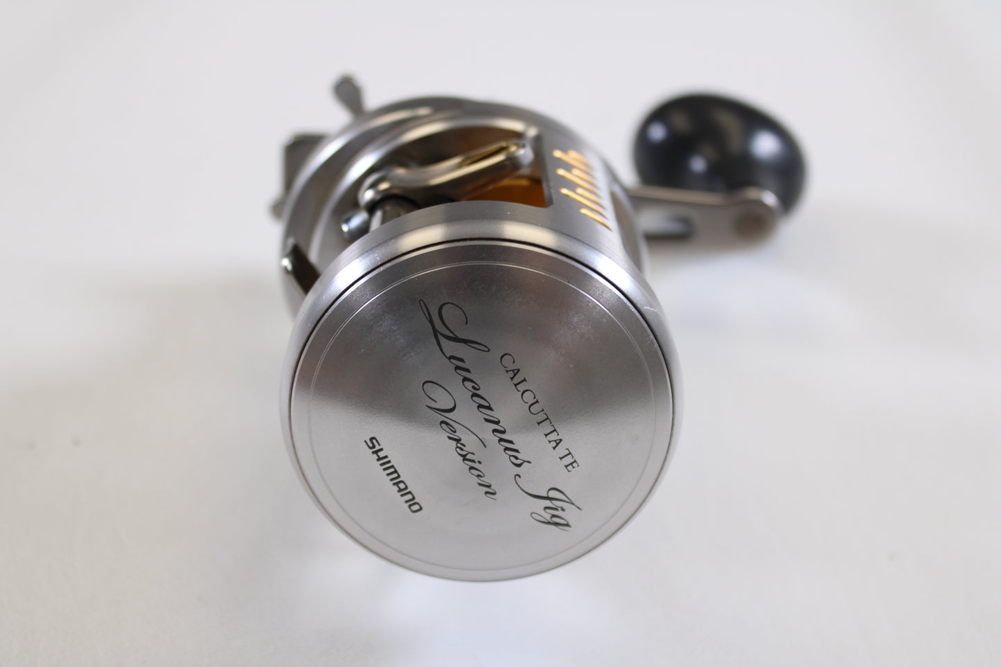 A close-up of a Shimano Calcutta TE Lucanus Jig Version CTE-400LJV RH used casting reel in excellent condition displays its engraved side plate—ideal for anglers trading in or upgrading used gear with our Rod and Reel Trade-In Program.