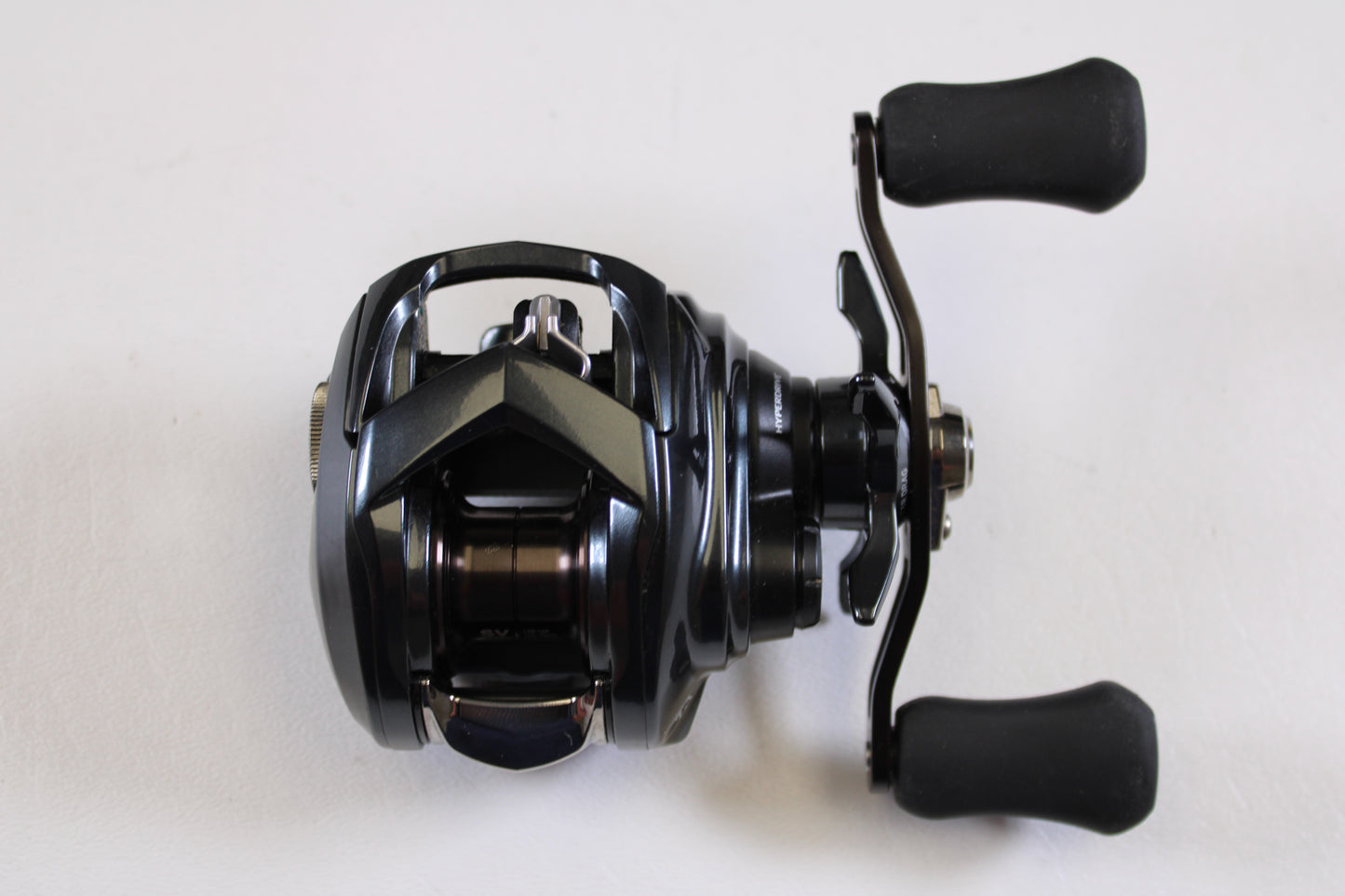 A close-up of a Daiwa Tatula SV TW 70 TTUSVTW70H 7.1:1 RH Used Casting Reel in excellent condition, shown on a plain white surface—ideal for anglers interested in quality used gear or considering a rod and reel trade-in.
