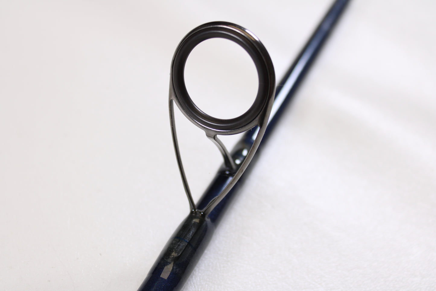 Close-up of the metal eyelet on this St. Croix Seage SES90MLMF2 9'0" Medium Light 2-piece used spinning rod in excellent condition—ideal for those interested in quality pre-owned gear from our Rod and Reel Trade-In Program.