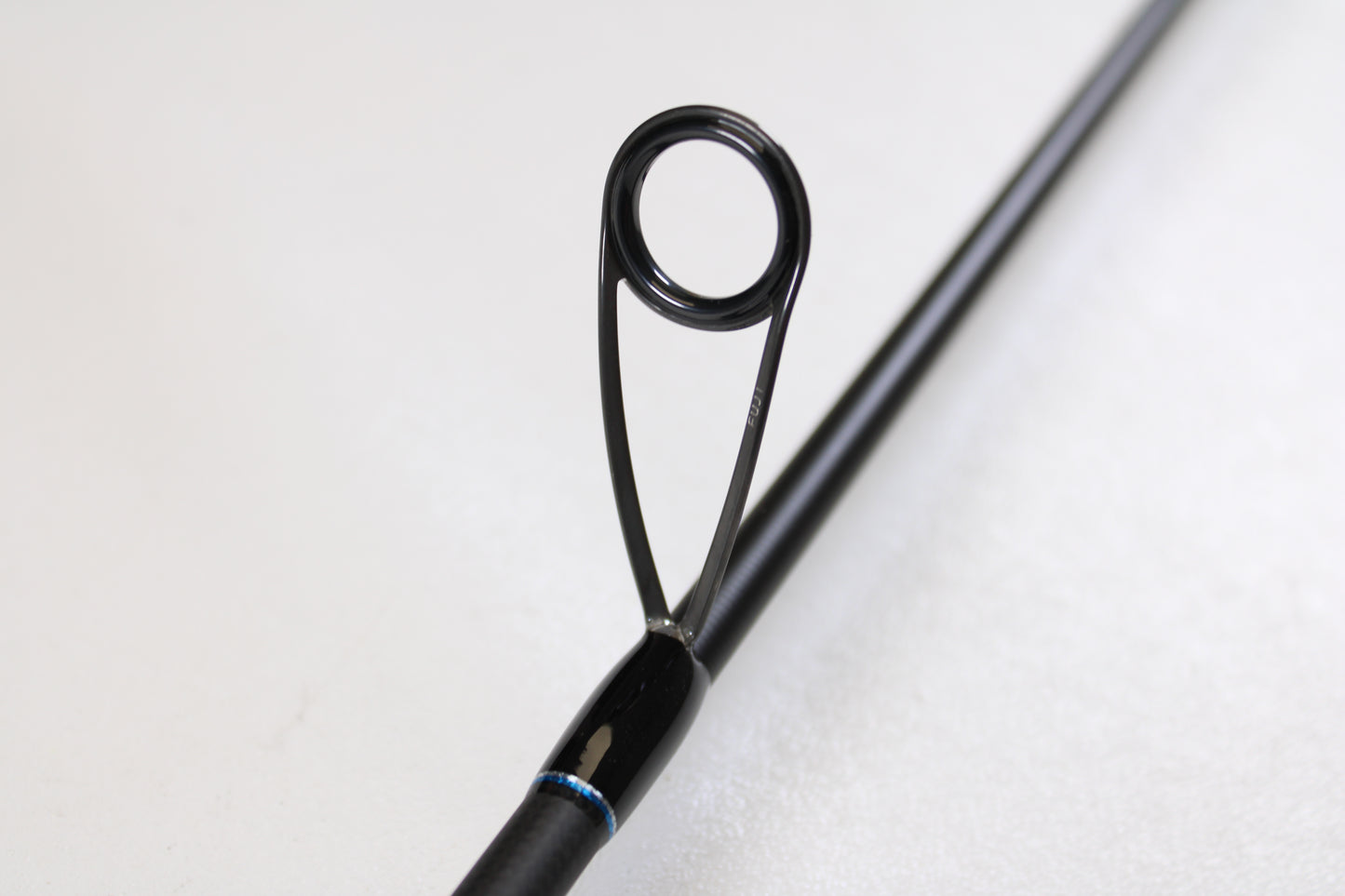 Close-up of the ODM Rods Genesis Inshore BXGX-701LS 7'0" Light—Used Spinning Rod in excellent condition. Features a circular metal guide ring with black supports, ideal for those exploring used gear or our rod and reel trade-in program.