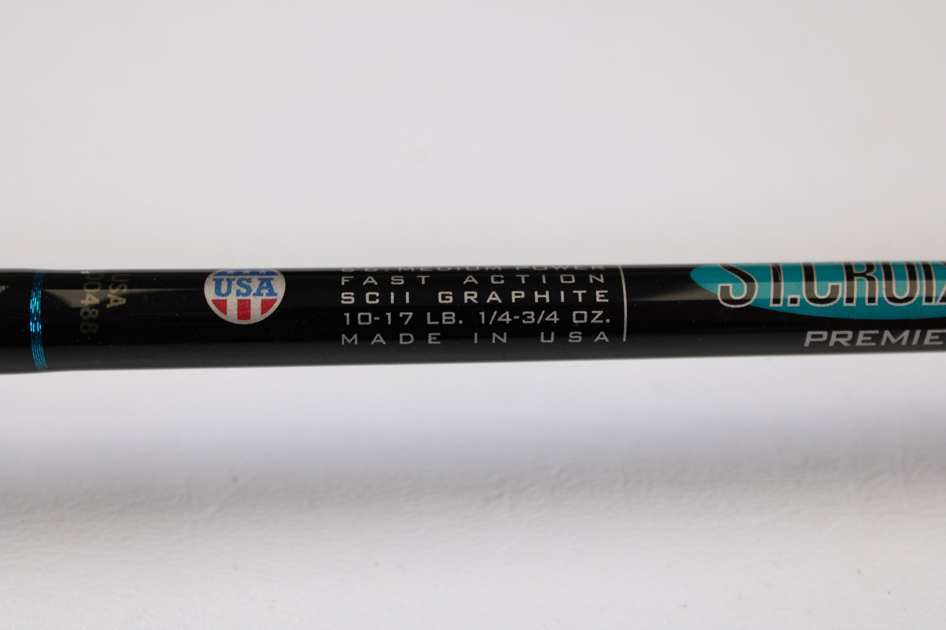 Close-up of a St. Croix Premier PC66MF 6'6" Medium Casting Rod in excellent condition, perfect for upgrading with our rod and reel trade-in for store credit. Text on the rod includes "USA," "FAST ACTION SCII GRAPHITE," and "MADE IN USA.