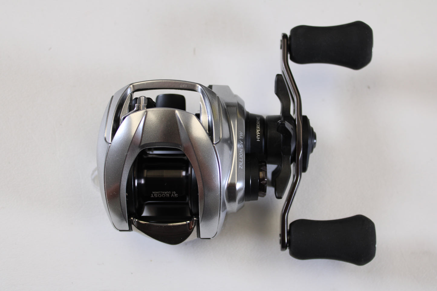 The Daiwa Zillion ZLNSVG100 6.3:1 RH Used Casting Reel—excellent condition with two black handles—perfect for anglers upgrading through our trade-in program or shopping quality used reels.