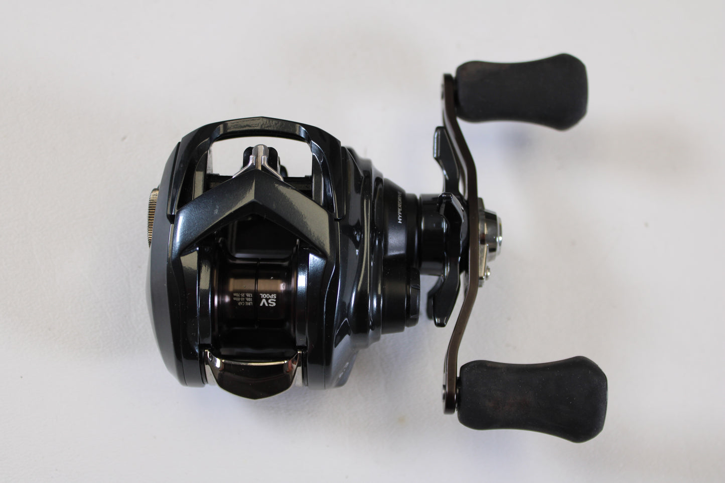The Daiwa Tatula SV 70 TTUSV70 6.3:1 RH Used Casting Reel (Excellent Condition) is shown, ideal for upgrading via our Rod and Reel Trade-In Program for store credit. Brand: Daiwa.