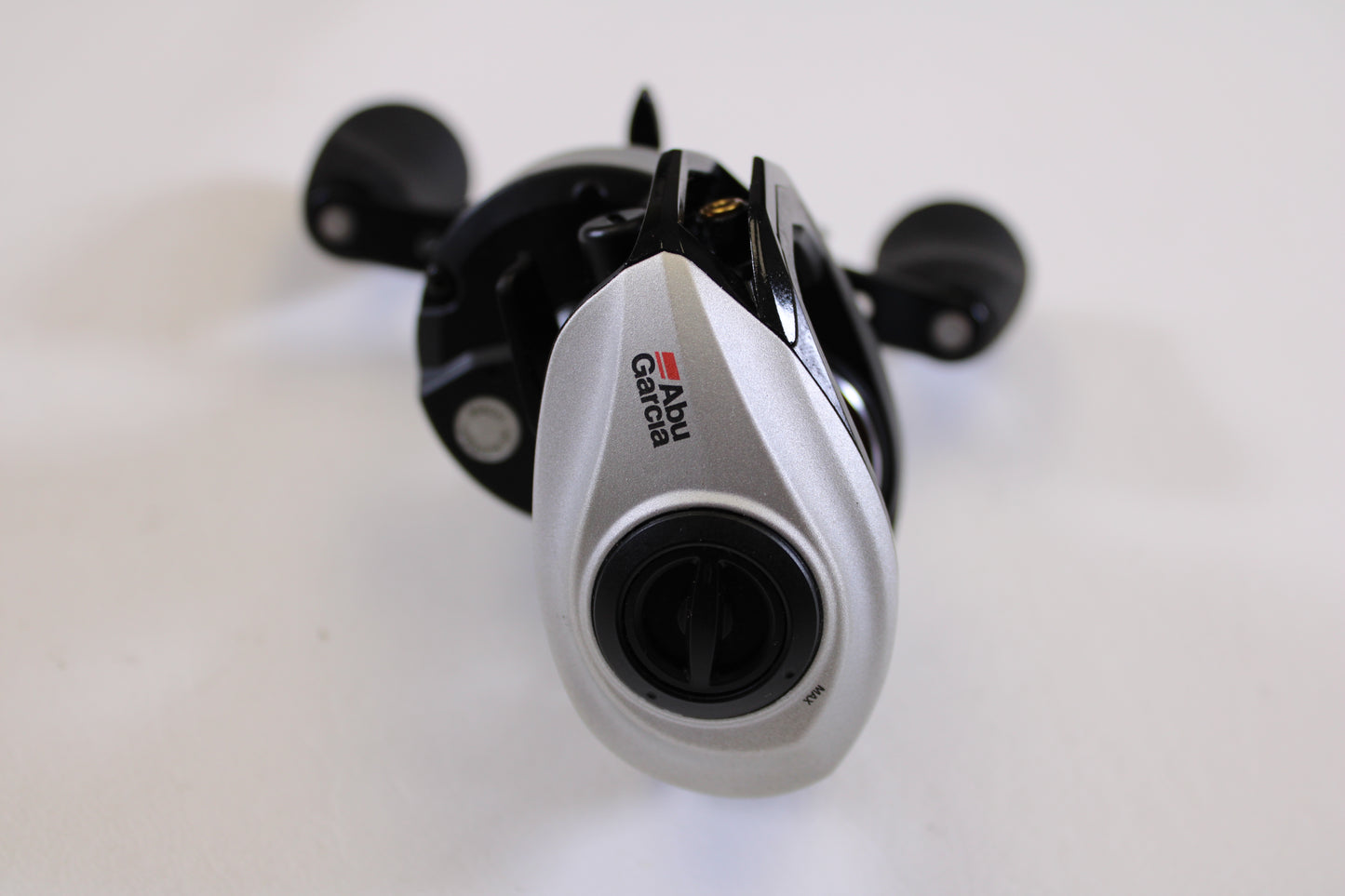 A close-up of an Abu Garcia Revo STX Gen 4 REVO3STX-SHS 8.0:1 RH Used Casting Reel in excellent condition, ideal for anglers interested in the Rod and Reel Trade-In Program for exchanging used gear for store credit.