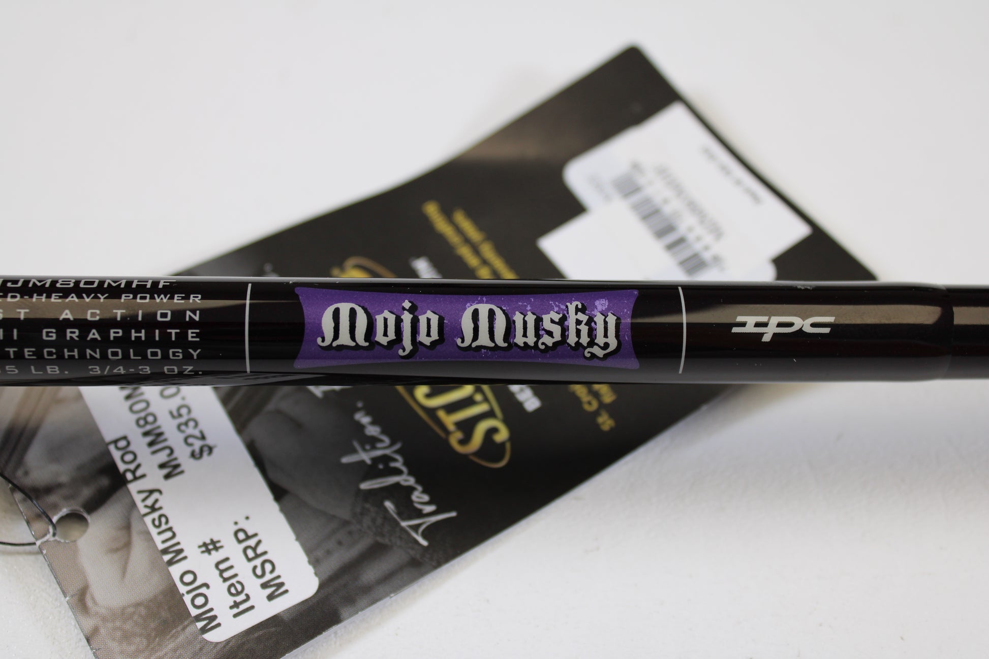 A close-up of a St. Croix Mojo Musky MJM80MHF 8'0" Medium Heavy Used Casting Rod in mint condition, with its black and purple label and visible product tag—ideal for fans of used gear or the Rod and Reel Trade-In Program.