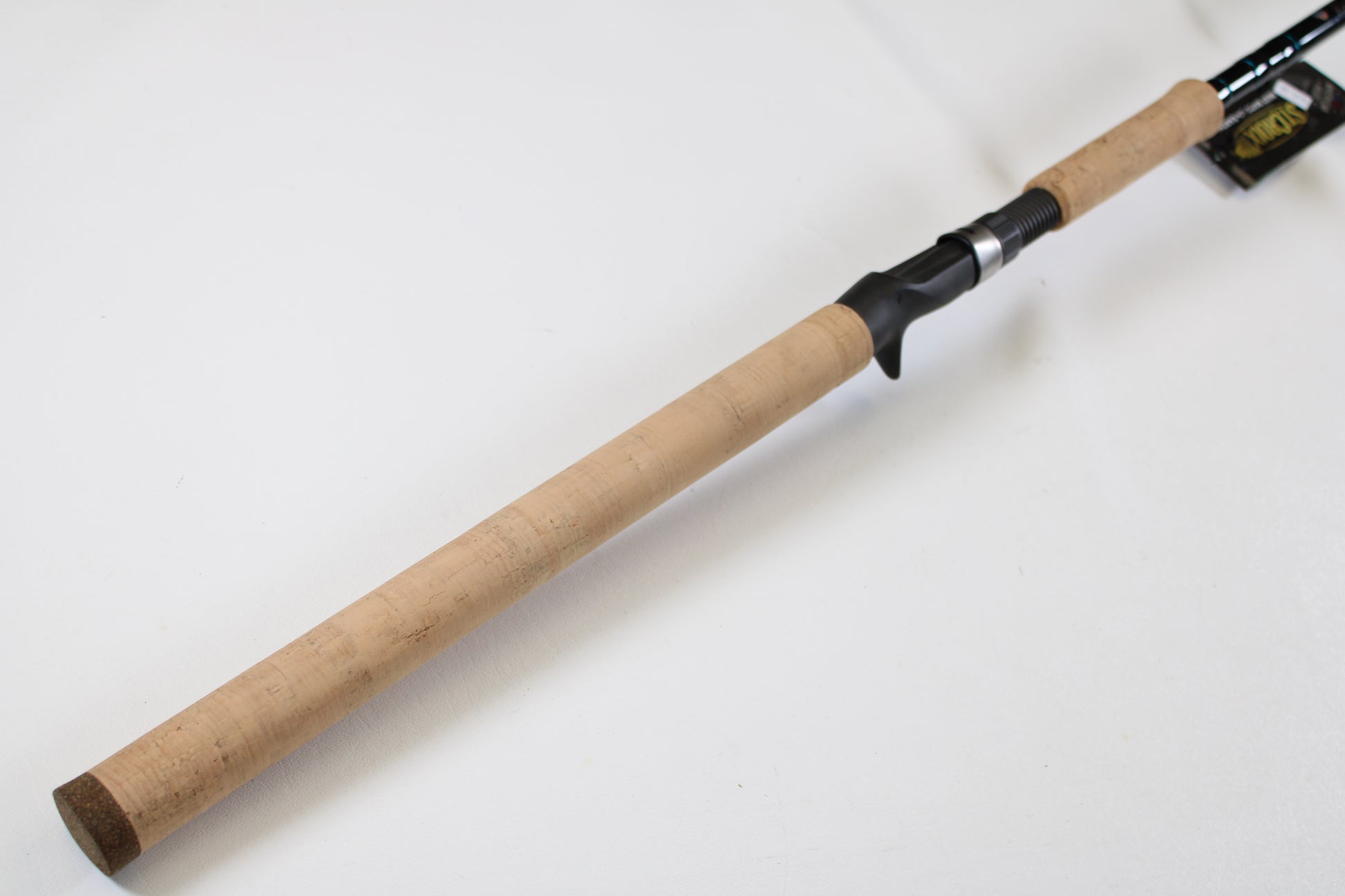 A close-up of the St. Croix Premier Musky PM80XHF 8'0" XH Used Casting Rod in mint condition, featuring a cork grip and black reel seat—ideal for those looking to trade in or upgrade their fishing gear for store credit.