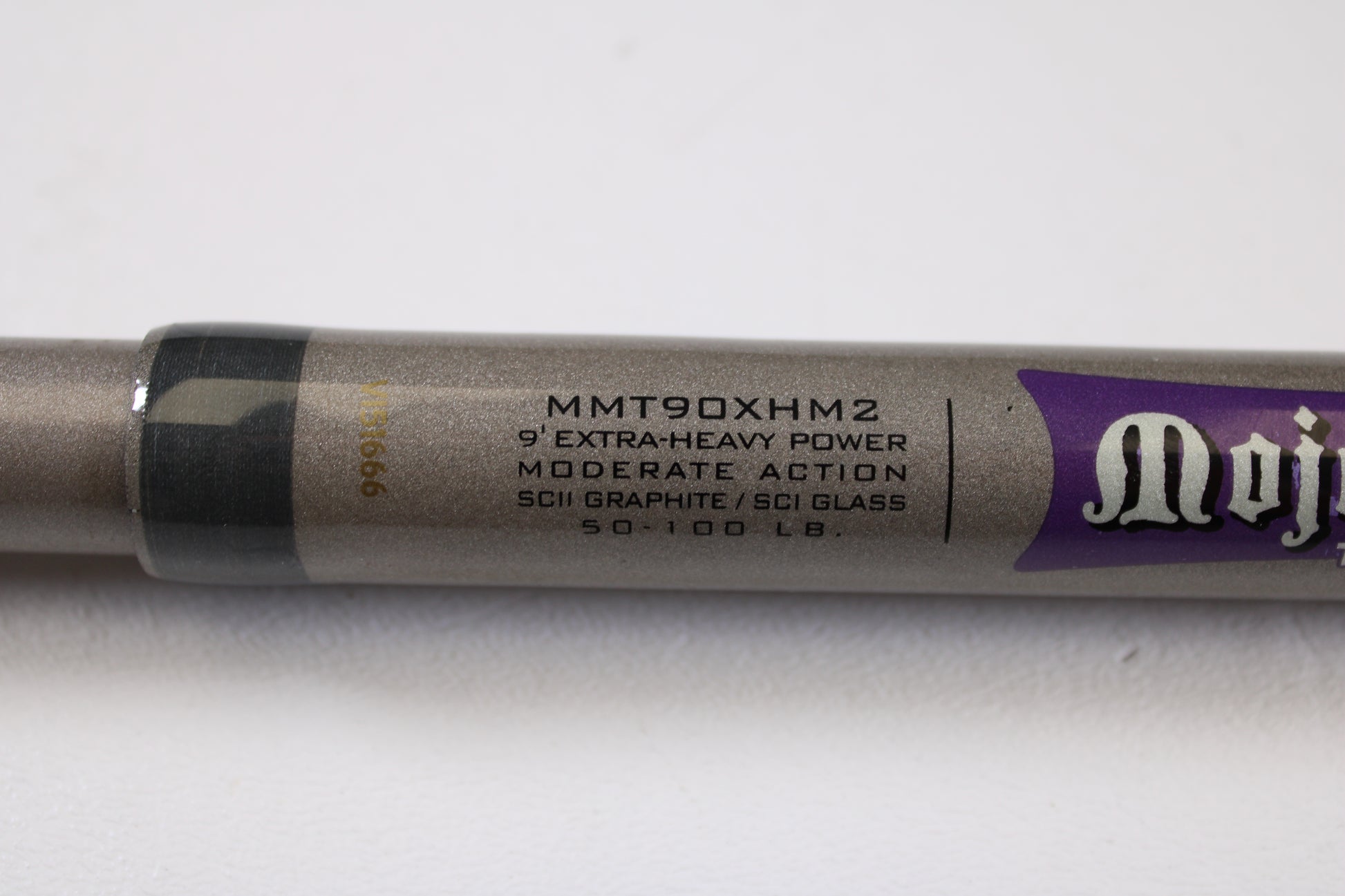 Close-up of St. Croix Mojo Musky Trolling MMT90XHM2 9'0" XH Used Casting Rod in metallic gray with a purple logo—ideal for store credit with our Rod and Reel Trade-In Program.