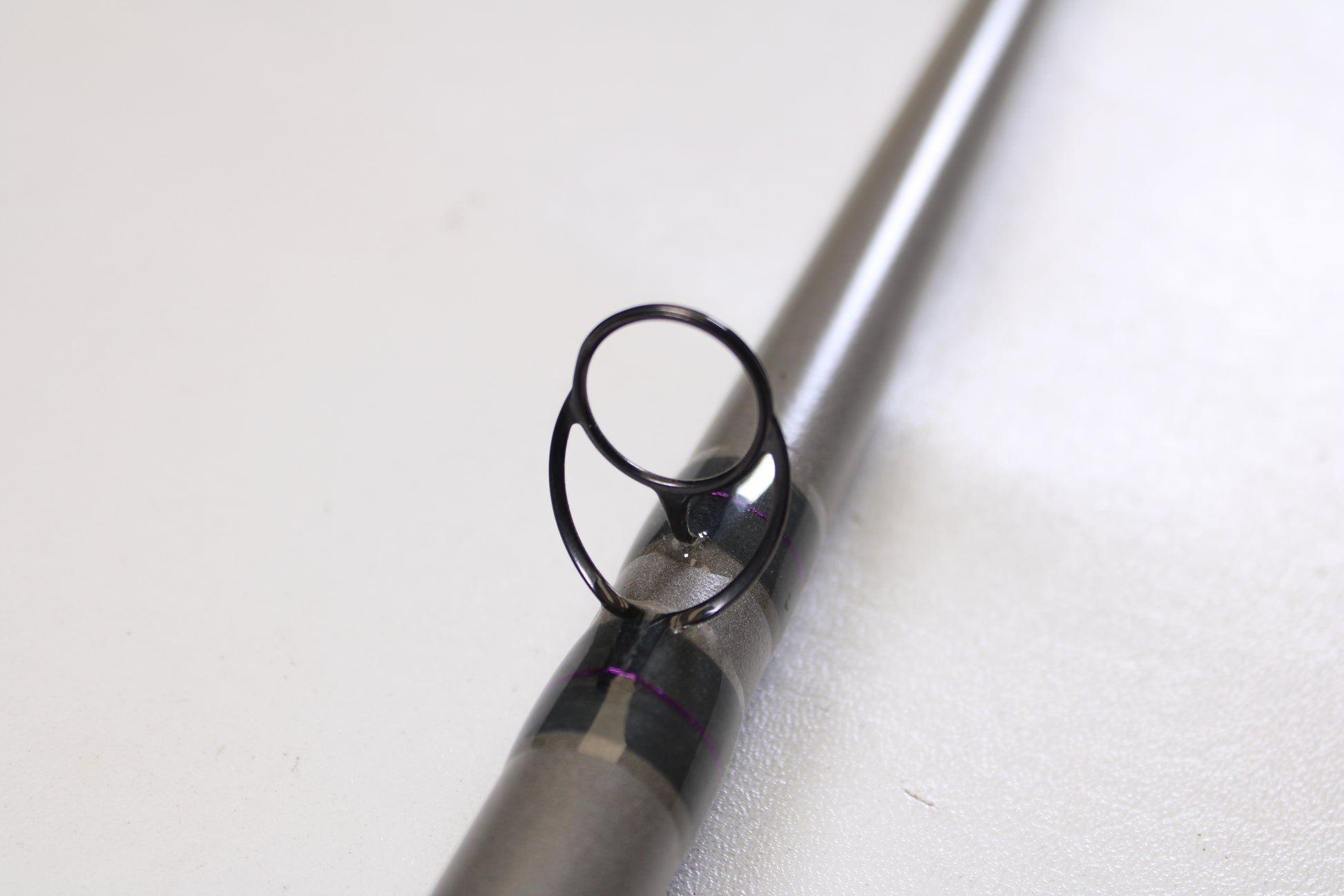 Close-up of the St. Croix Mojo Musky Trolling MMT90XHM2 9'0" XH used casting rod’s guide ring and support—ideal for anglers trading in gear for store credit with our Rod and Reel Trade-In Program. Mint condition. Set against a white background.
