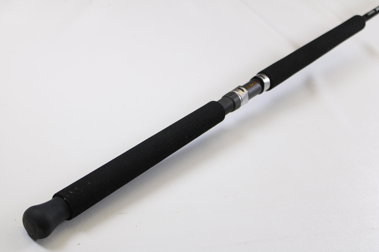 A close-up of the G. Loomis IMX-PRO Offshore 96-20 8'0" Medium Light Used Casting Rod’s black foam handle and reel seat—ideal for our Rod and Reel Trade-In Program, where you can earn store credit for used G. Loomis gear.