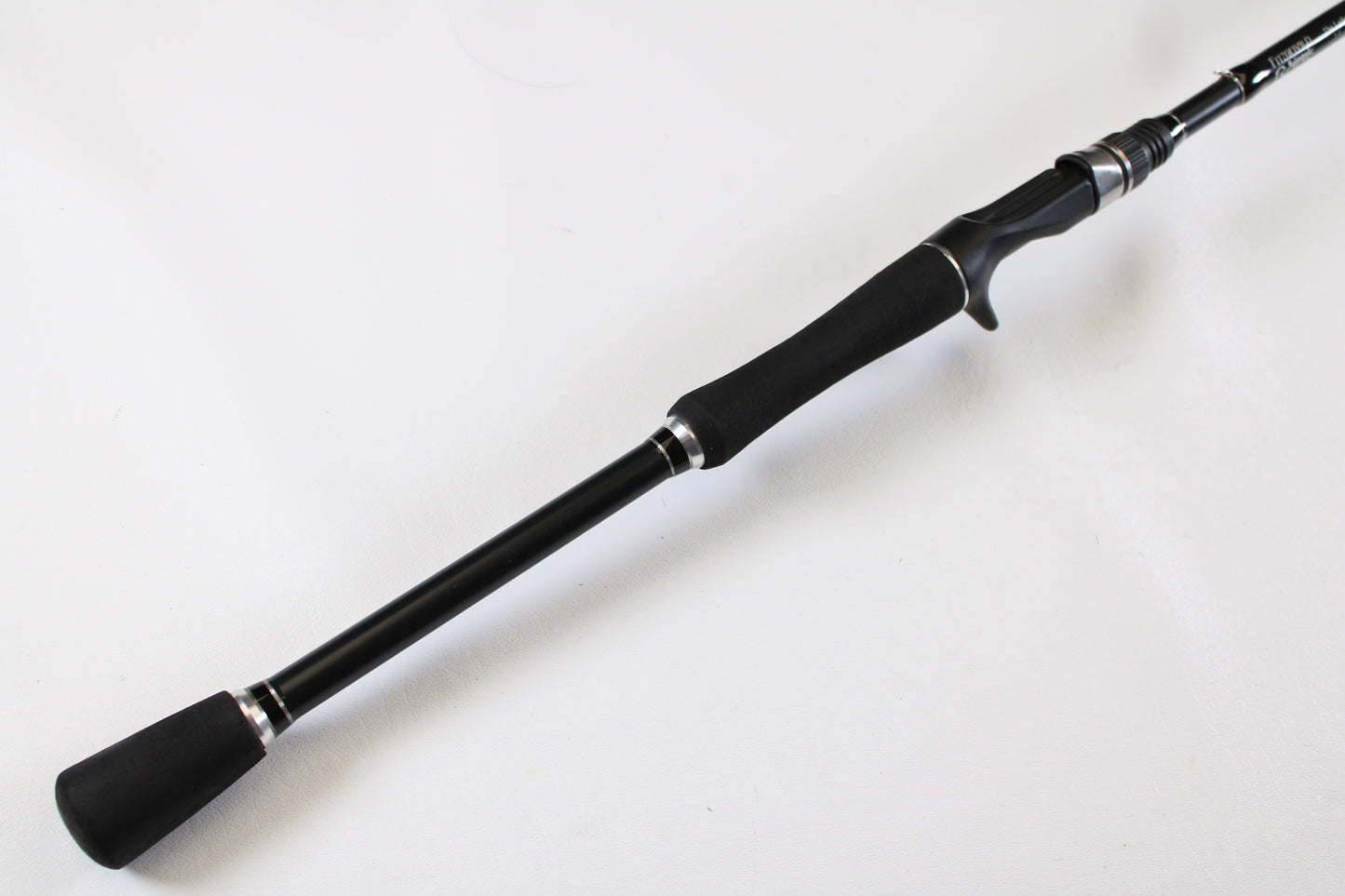 A close-up of the Fitzgerald Original TLR710H The Ledge Rod 7'10" Heavy, a used casting rod in very good condition with foam grips and reel seat—ideal for our Rod and Reel Trade-In Program if you want to upgrade for store credit.