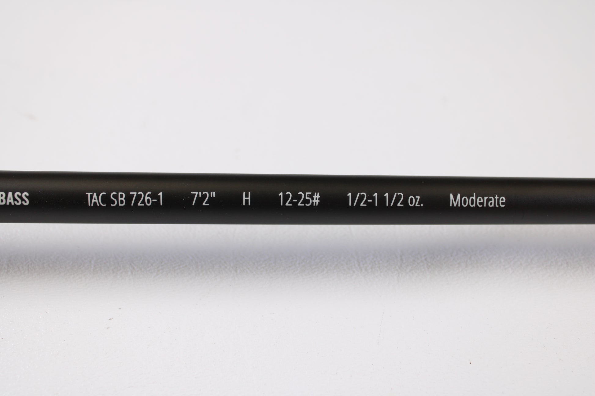 A close-up of the Temple Fork Tactical Bass TAC SB 726-1 7'2" Heavy Used Casting Rod in excellent condition, showing model text on a white background—ideal for those exploring our Rod and Reel Trade-In Program.