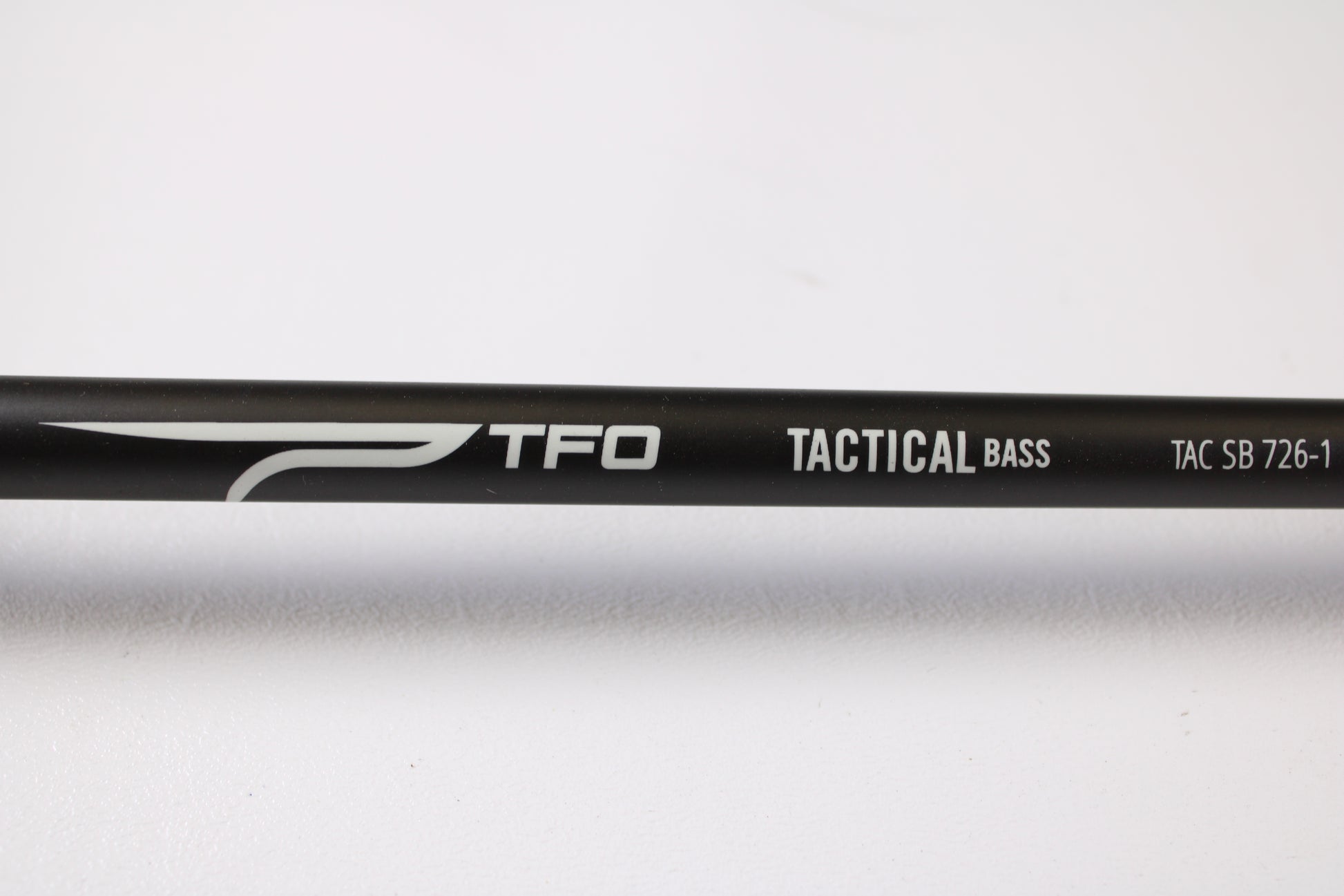 A close-up of a Temple Fork Tactical Bass TAC SB 726-1 7'2" Heavy Used Casting Rod in excellent condition on a white background—ideal for those exploring our Rod and Reel Trade-In Program or shopping quality used gear.