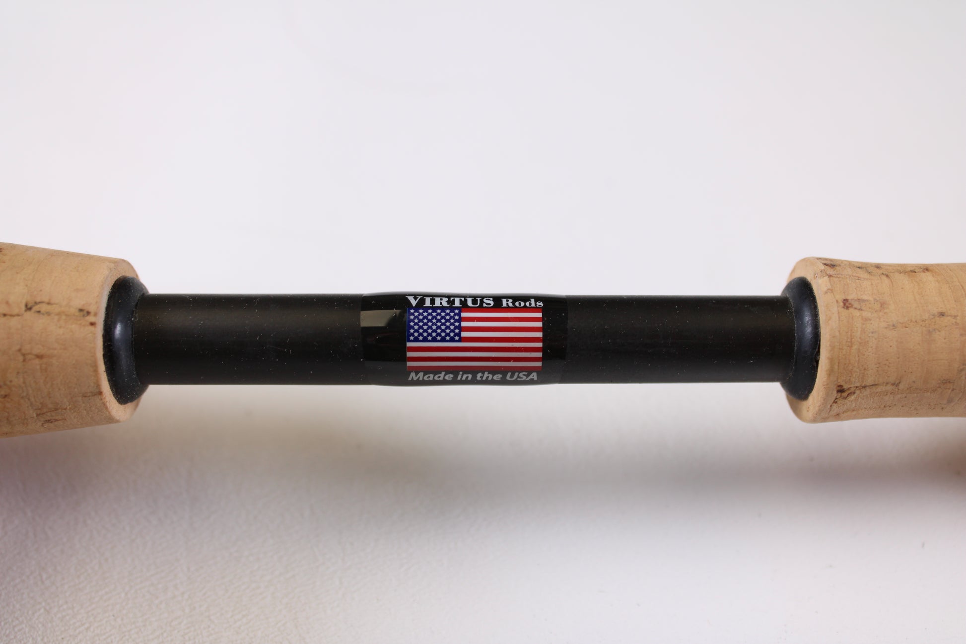 A close-up of the Jewel Virtus Stickbait 6'8" Medium Used Casting Rod handle, labeled with an American flag, "VIRTUS Rods," and "Made in the USA" on a black section between cork grips—ideal for used gear seekers or trade-in program shoppers.