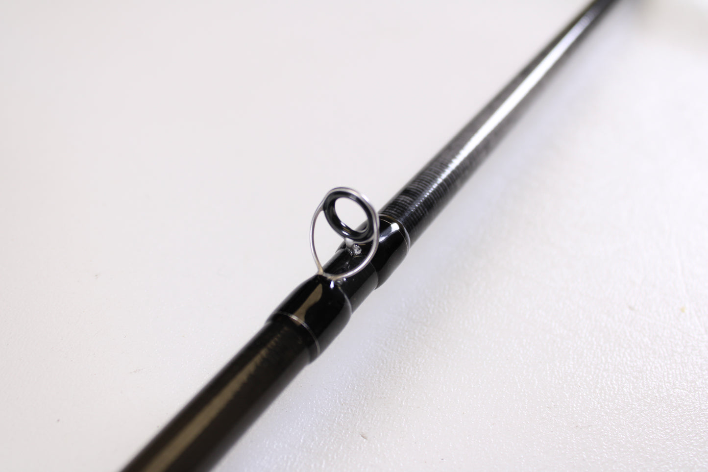 Close-up of the Evergreen Combat Stick RCTC-73MH Jig & Worm 7'3" Medium Heavy—Used Casting Rod in excellent condition, highlighting a metal line guide against a white background—great for those interested in rod trade-ins or used gear.