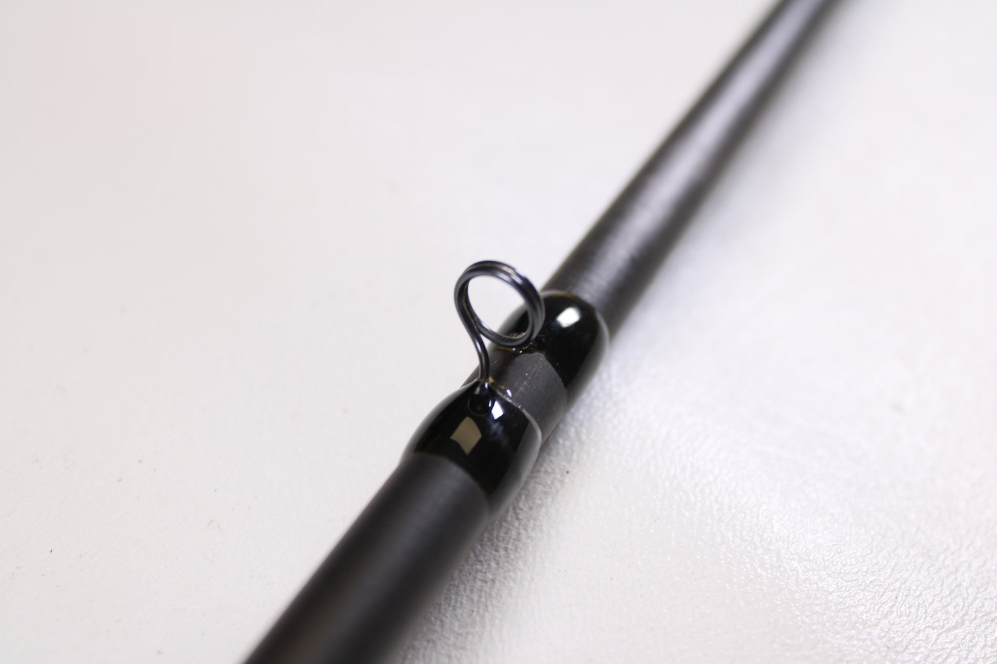 Close-up of a 13 Fishing Envy Black EBC76H 7'6" Heavy used casting rod in very good condition, highlighting the line guide—an ideal choice for our Rod and Reel Trade-In Program.
