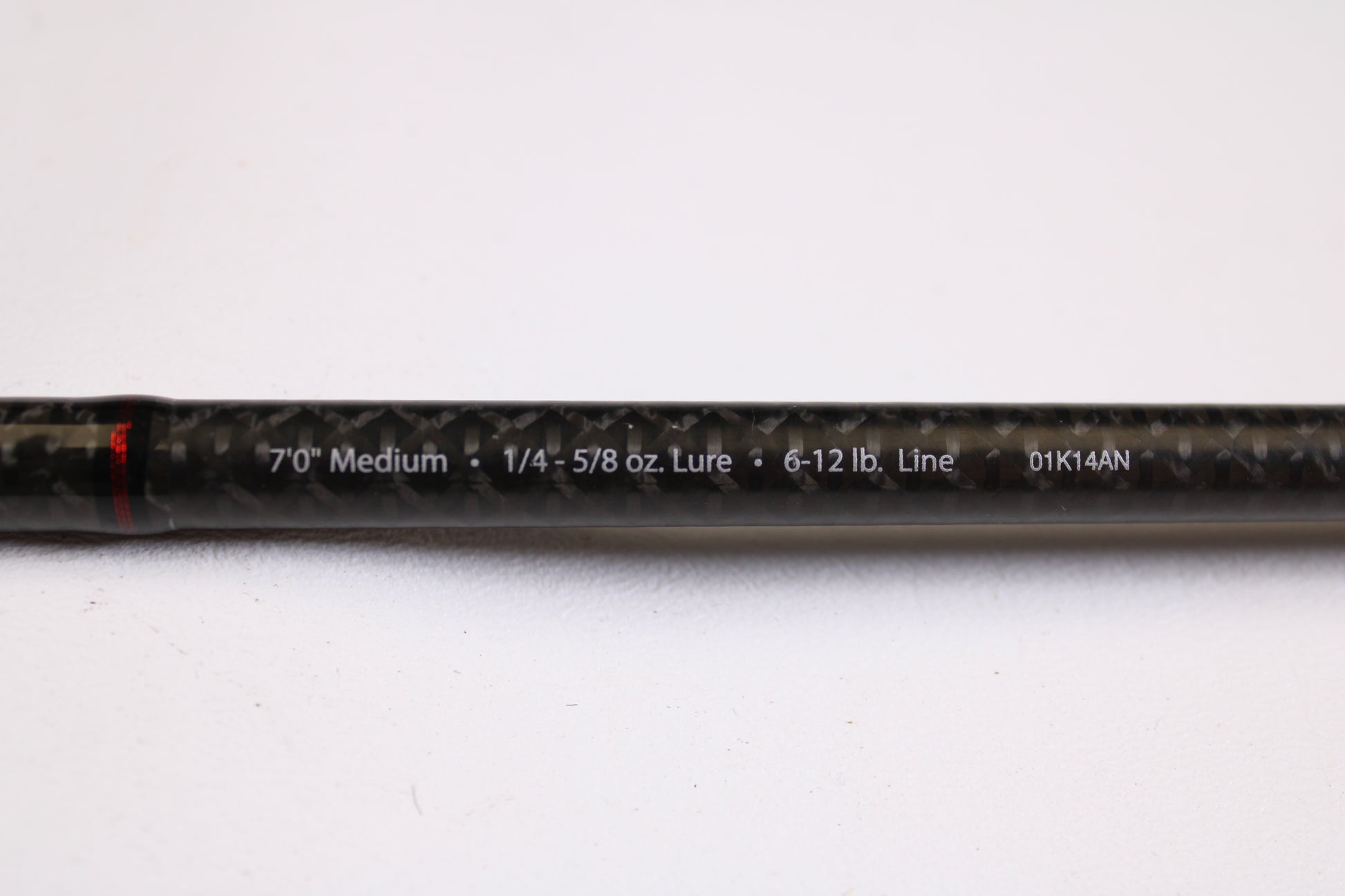 A close-up of an Abu Garcia Fantasista Regista FNRS70-5 7'0" Medium Used Spinning Rod in very good condition, showing specs on its black carbon fiber surface—ideal for our Rod and Reel Trade-In Program for store credit.