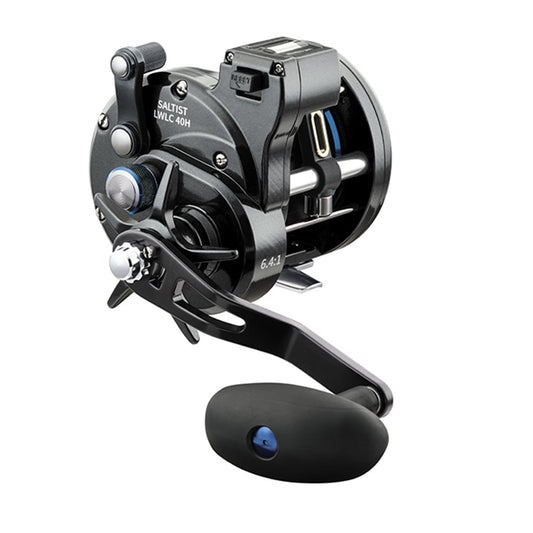 The Daiwa Saltist Levelwind Line Counter Conventional Reel 40LCH 6.4:1, labeled STTLW40LCH, features a black design with silver and blue accents. It is equipped with a large ergonomic handle and durable frame, making it ideal for heavy-duty saltwater fishing.