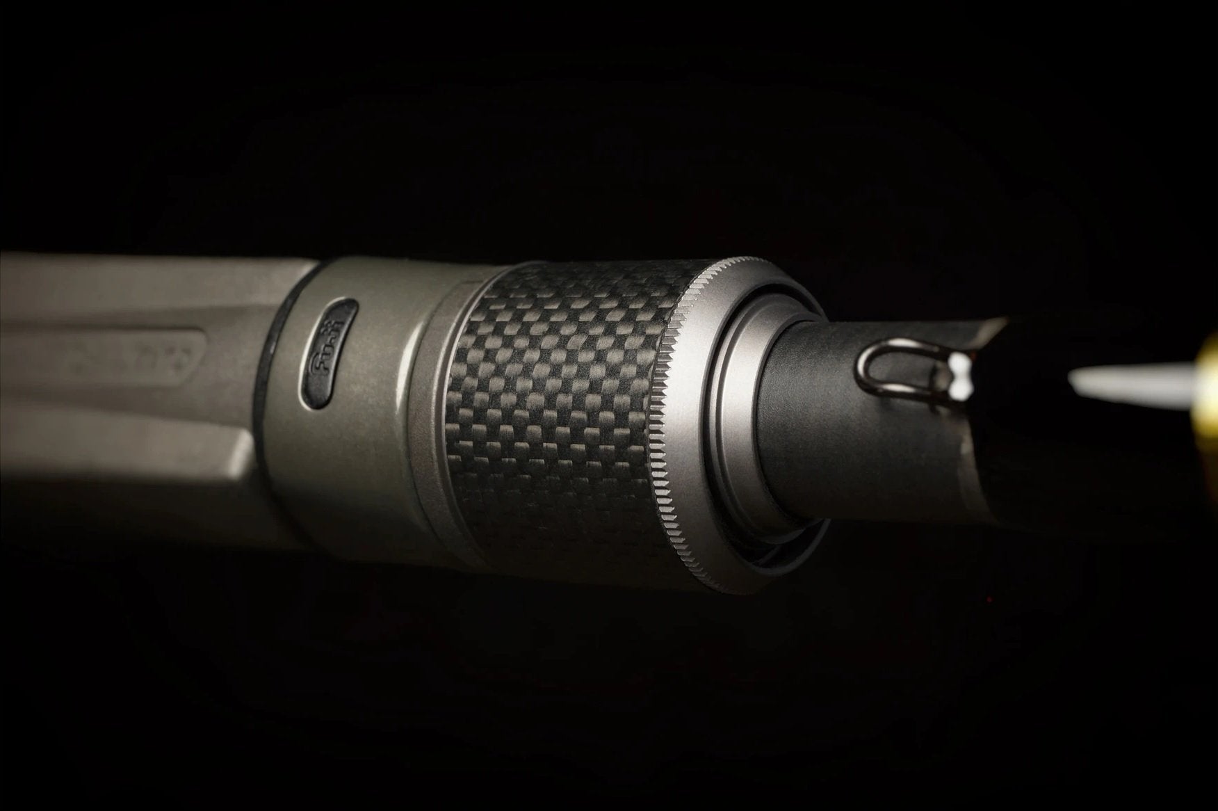 Close-up of the Falcon Cara Casting Rod Head Turner 6'10" Heavy (CC-6-1610) barrel and muzzle, highlighting textured metal and carbon fiber rod details against a dark background.