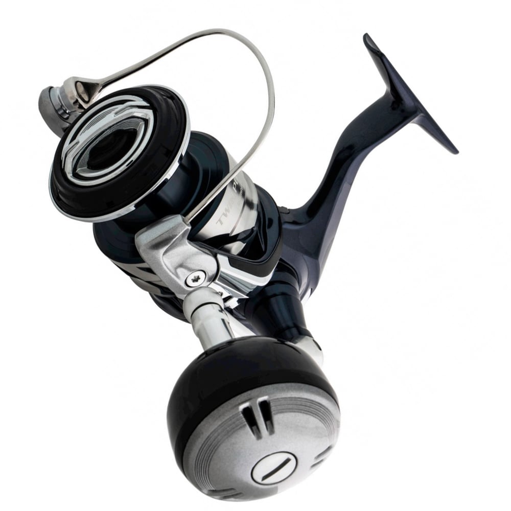 A close-up of the Shimano Twin Power SW Spinning Reel 8000HGC 5.6:1 by Shimano, in black and silver, showcases its detailed handle, spool, and bail arm against a white background—ideal for offshore game fish anglers.