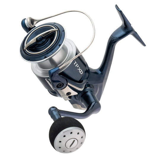 A close-up of the Shimano Twin Power XD Spinning Reel 5000XGFA 6.2:1 by Shimano, showcasing its metallic blue and silver finish, large handle with black grip, and "TPXDC5000XGFA" marking on the body.