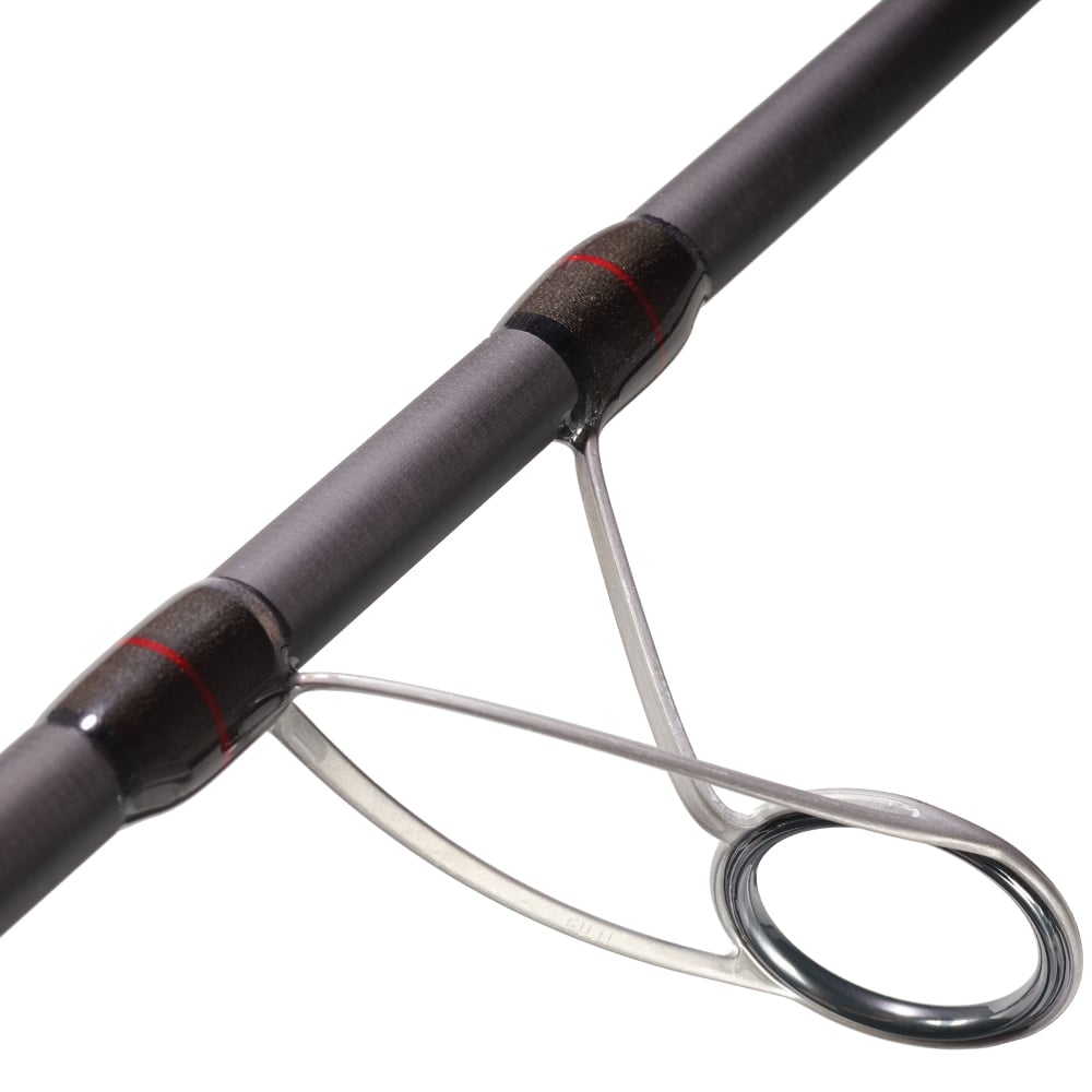 Close-up of the St. Croix Avid Surf Spinning Rod 12’0” Heavy (VSS120HMF2), highlighting a metal line guide on the SCIII carbon blank, secured with black and red wrappings for enhanced casting distance.