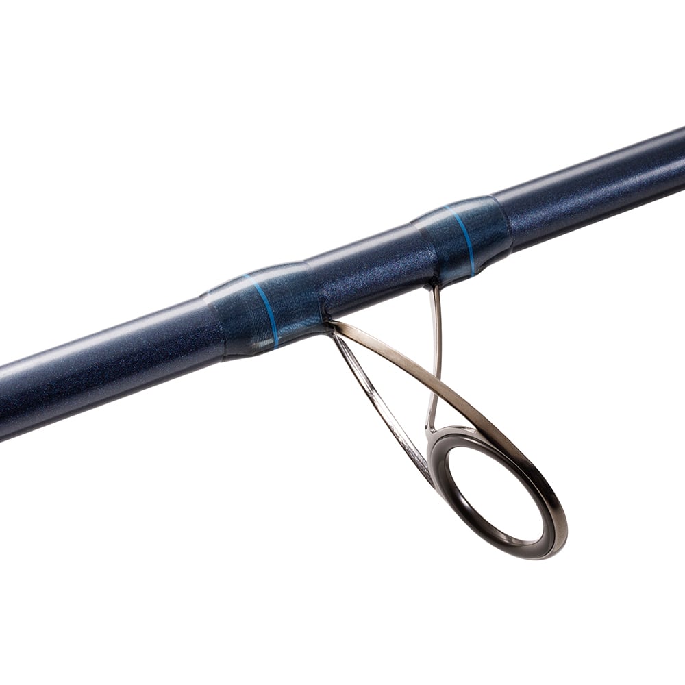 Close-up of a sleek, shiny metal ring attached to a glossy blue St. Croix Seage Surf Series Spinning Rod by americanlegacyfishing. The picture highlights the craftsmanship and SCII carbon fiber technology used in the guide component of the 9’0” Medium Moderate Fast 2-piece rod, model SES90MMF2.