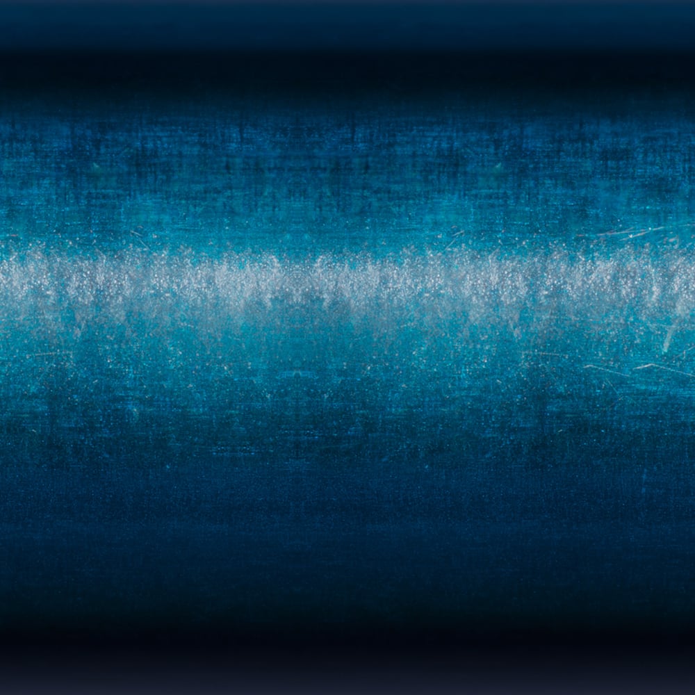 Abstract image featuring horizontal bands of dark blue and teal, with a bright, textured white streak inspired by the sleek design of the St. Croix Triumph Travel Spinning Rod 5'6” Ultra Light (TSR56ULF4), evoking depth and glowing energy.