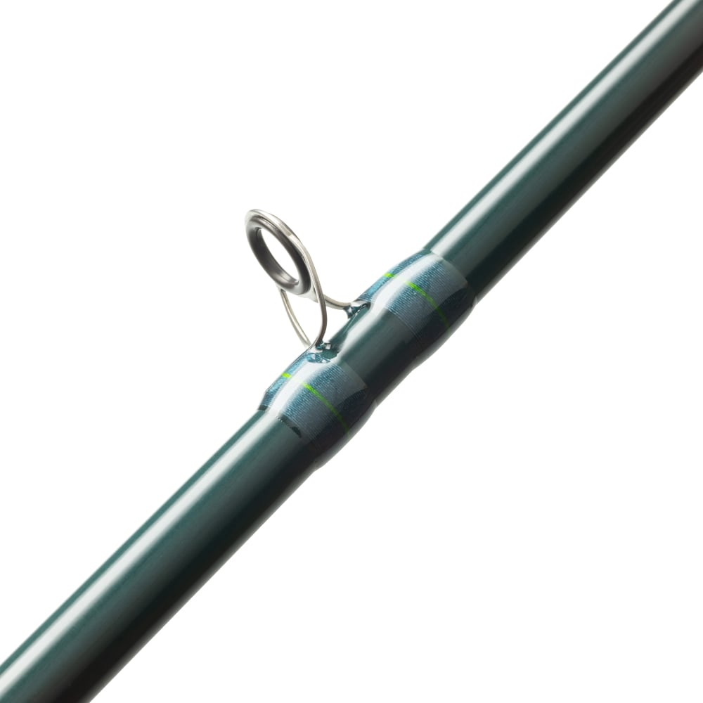 Close-up of a St. Croix Triumph Inshore Casting Rod 7'0" Medium Light (TRIC70MLM) with a metal guide ring, blue and green thread wraps, and SCII Carbon construction. The white background highlights the rod's features.
