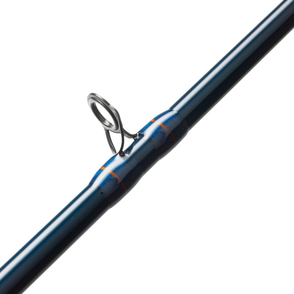 Close-up of the St. Croix Triumph Musky Casting Rod 7'6” Heavy, showing a metal guide ring secured with orange and blue thread wraps on its premium SCII carbon blank for heavy action performance.