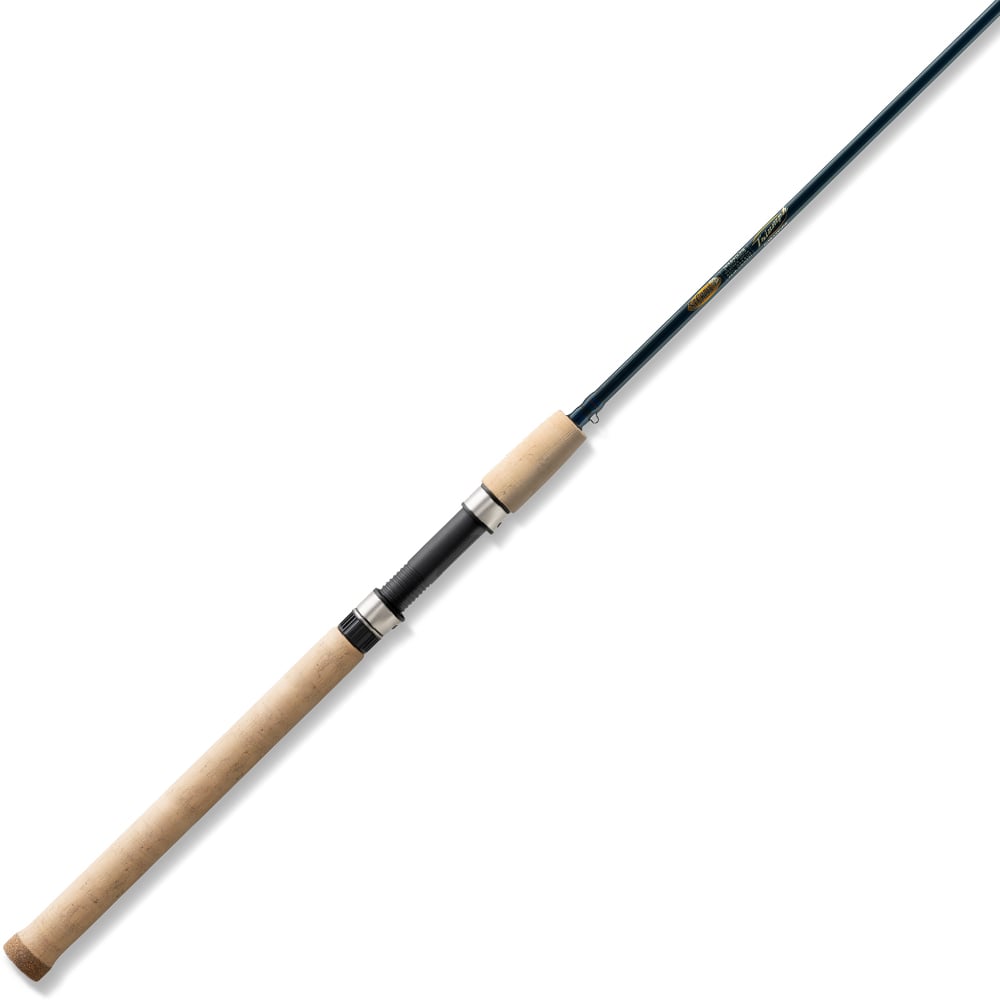 The St. Croix Triumph Salmon & Steelhead Spinning Rod 8'6" Medium (TRSS86MF2) features a long cork handle, silver reel seat, and slender dark Premium SCII Carbon shaft, shown diagonally on a white background.