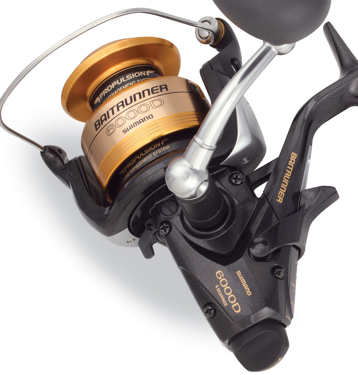 A close-up of the Shimano Baitrunner BTR6000D Spinning Fishing Reel by Shimano shows its gold and black design, branded spool and handle, and highlights its advanced Propulsion Line Management System.