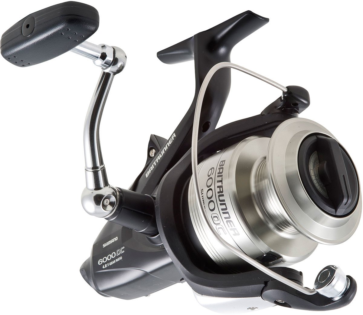 A close-up of the Shimano SHIMANO Baitrunner OC BTR6000OC Spinning Reel, highlighting its metallic silver spool, black body and handle, as well as the attached bail arm.