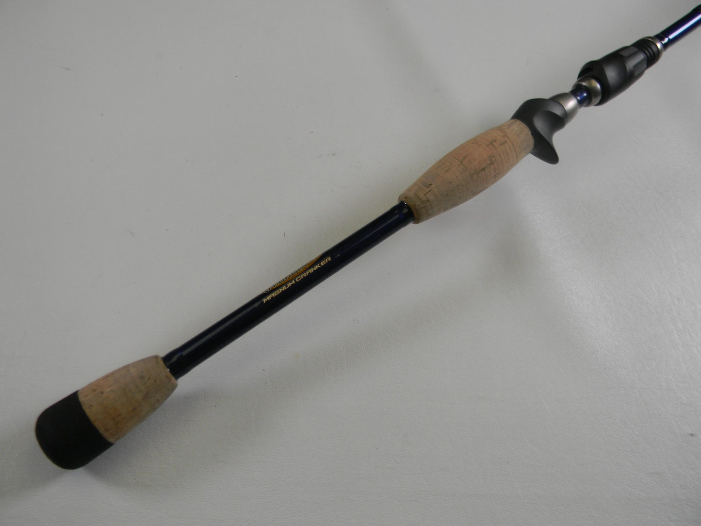 A close-up of the St. Croix Legend Tournament Bass TBC710HM Magnum Cranker 7'10" Heavy casting rod with cork grips and a black finish—an excellent used option for anglers or those joining our Rod and Reel Trade-In Program.