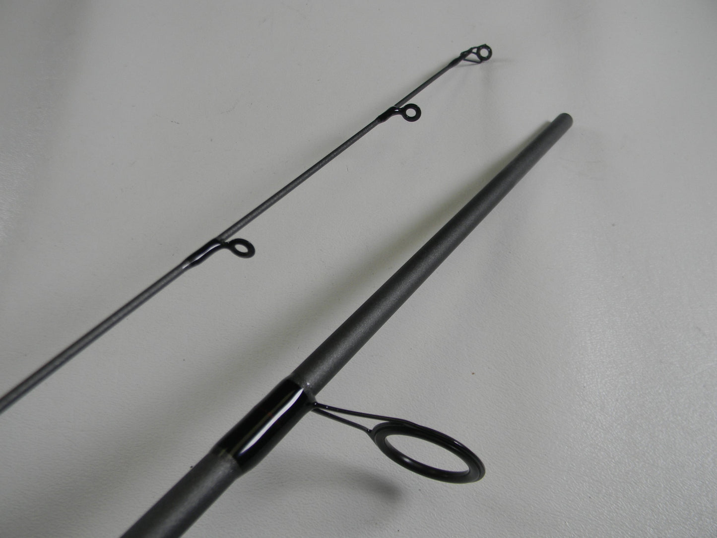 Close-up of a St. Croix X Trek CTCS70MF2-C 7'0" Medium used spinning rod in excellent condition, shown separated to highlight its black line guides and smooth finish—ideal for our Rod and Reel Trade-In Program or store credit.