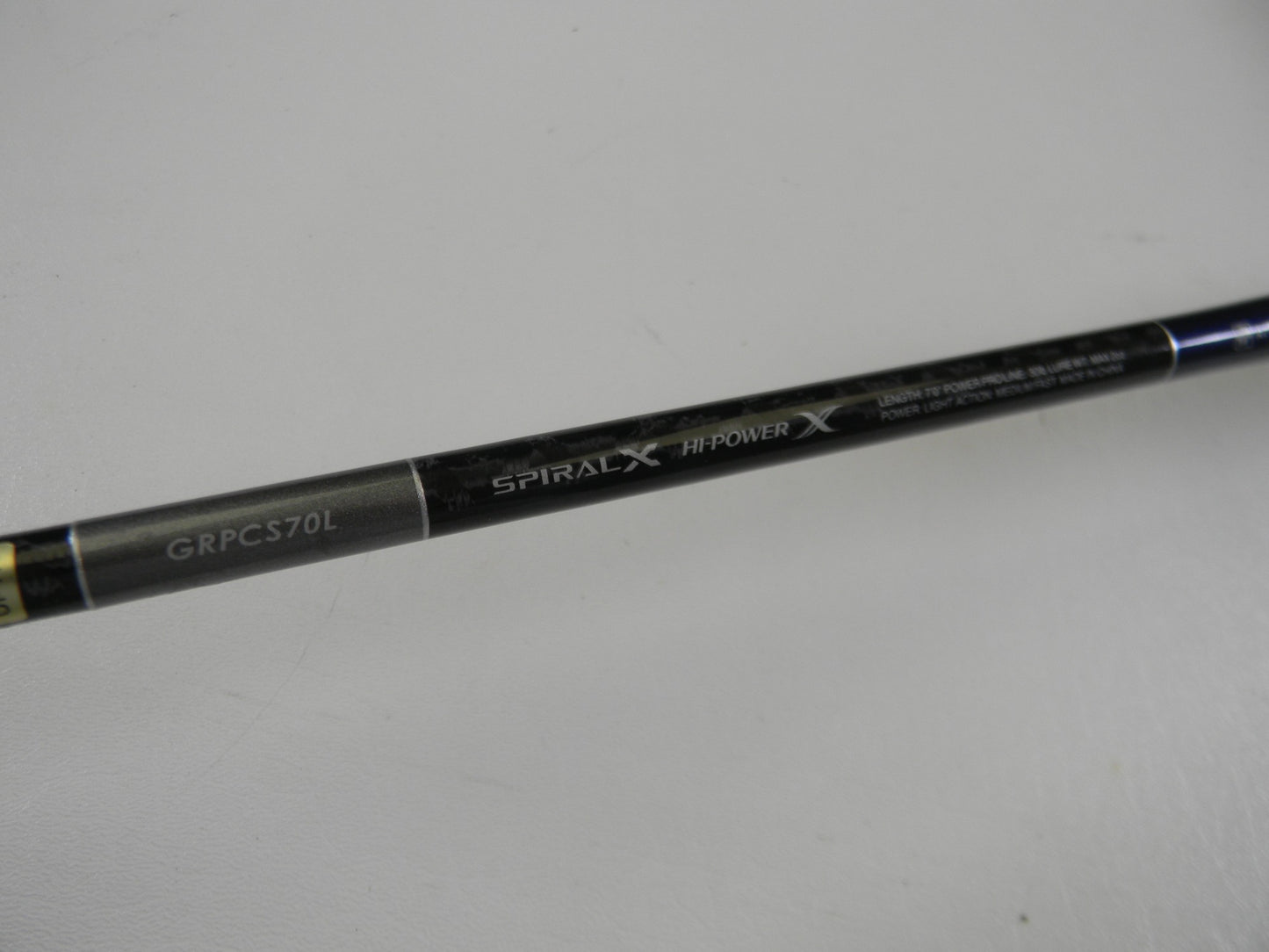 A close-up of a Shimano Grappler Type C GRPCS70L 7'0" Light Used Spinning Rod in excellent condition, showing "GRPCS70L," "SPIRAL X," and "HI-POWER X"—ideal for upgrading with our Rod and Reel Trade-In Program.