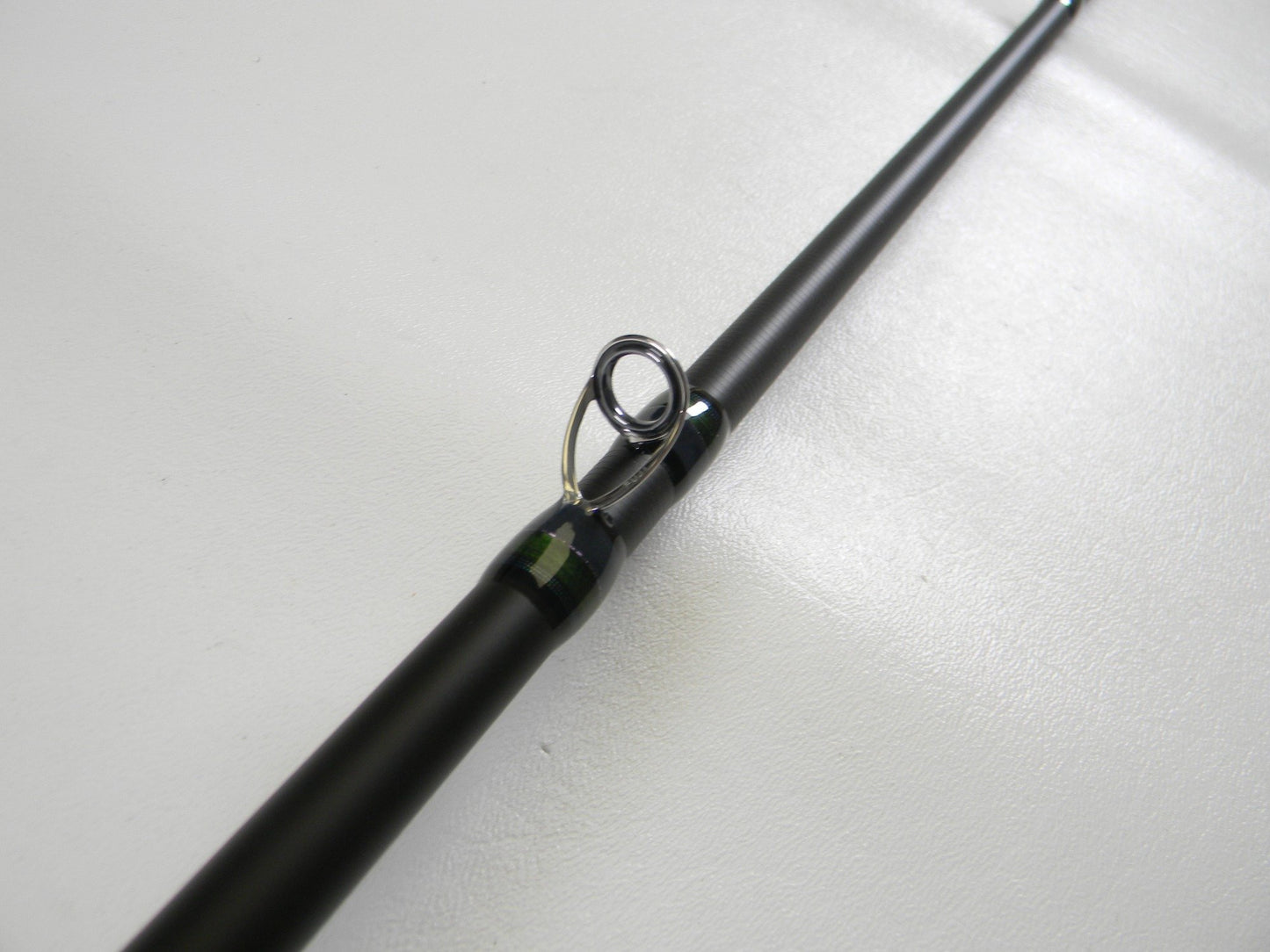 Close-up of a Megabass Orochi X10 F7-71XT Swamp Survivor 7'1" Heavy Used Casting Rod in excellent condition, highlighting its metal line guide—ideal for those seeking top-quality, pre-owned Megabass fishing gear.