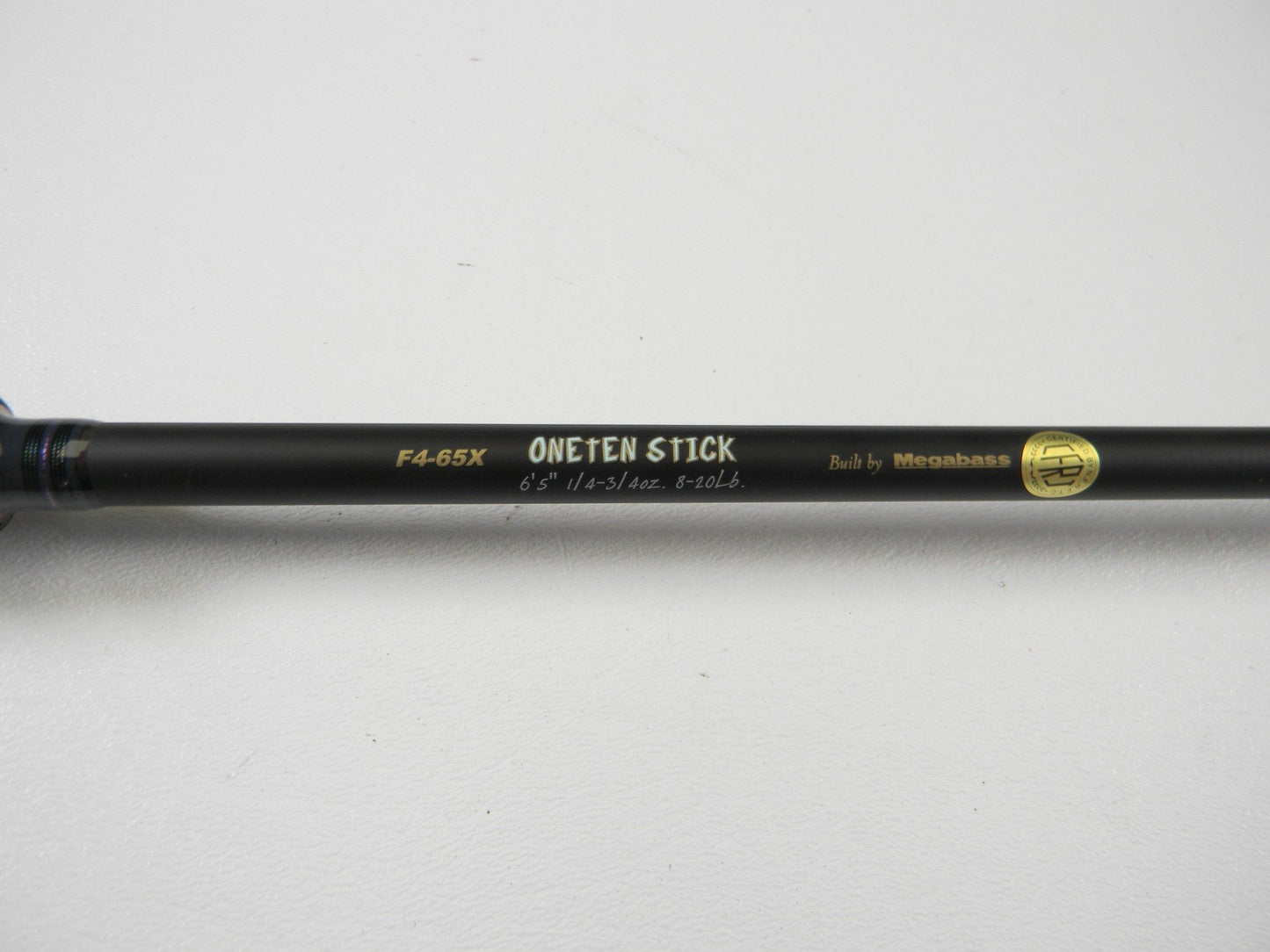 Close-up of the Megabass Destroyer P5 F4-65X OneTen Stick 6'5" Medium Used Casting Rod in excellent condition—ideal for our Rod and Reel Trade-In Program or earning store credit on pre-owned Megabass gear.