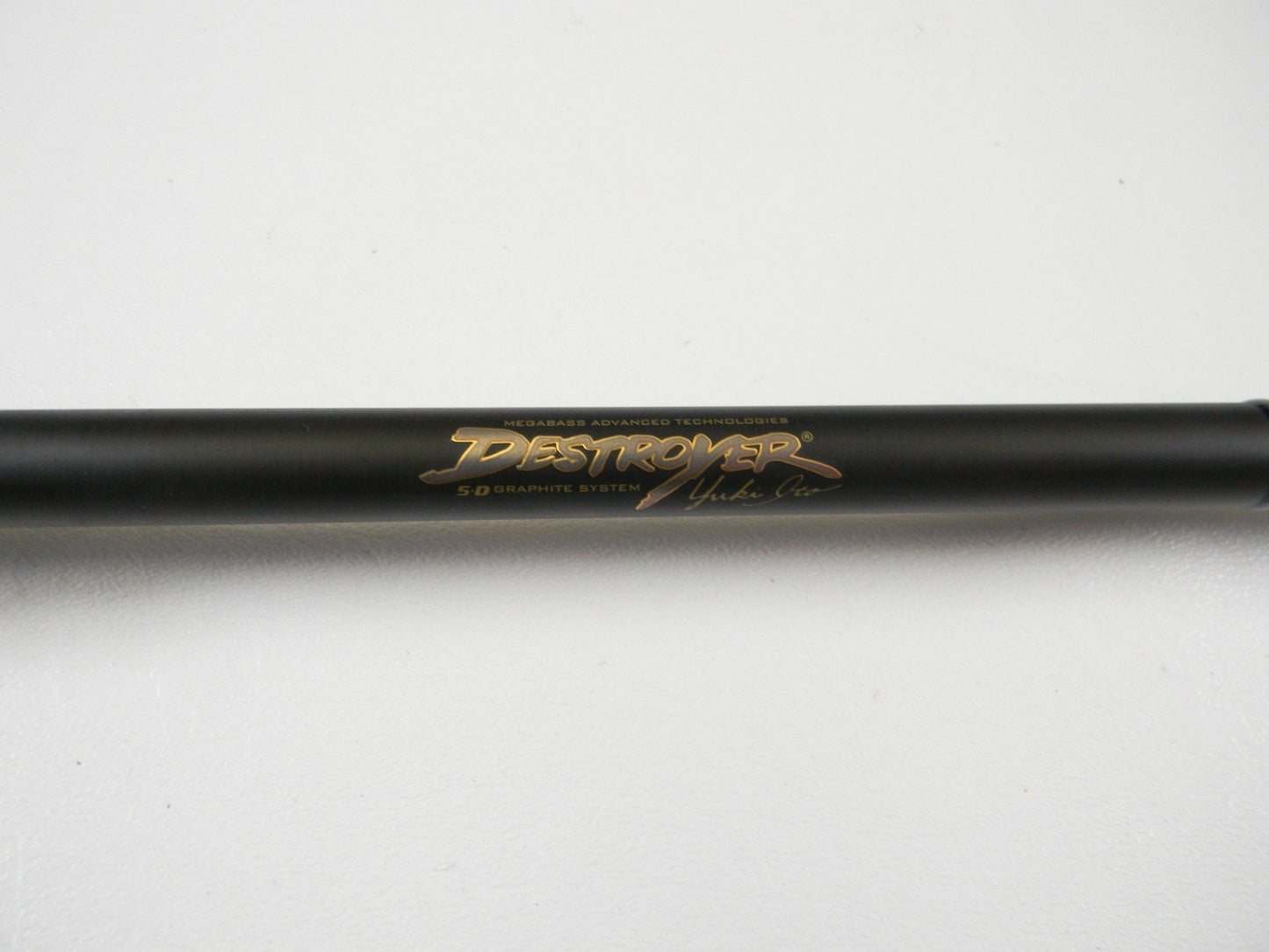A close-up of the Megabass Destroyer P5 F7-75X BMG 7'5" Heavy Used Casting Rod in excellent condition, featuring gold "DESTROYER" and "5D GRAPHITE SYSTEM" text—ideal for our Rod and Reel Trade-In Program or store credit.