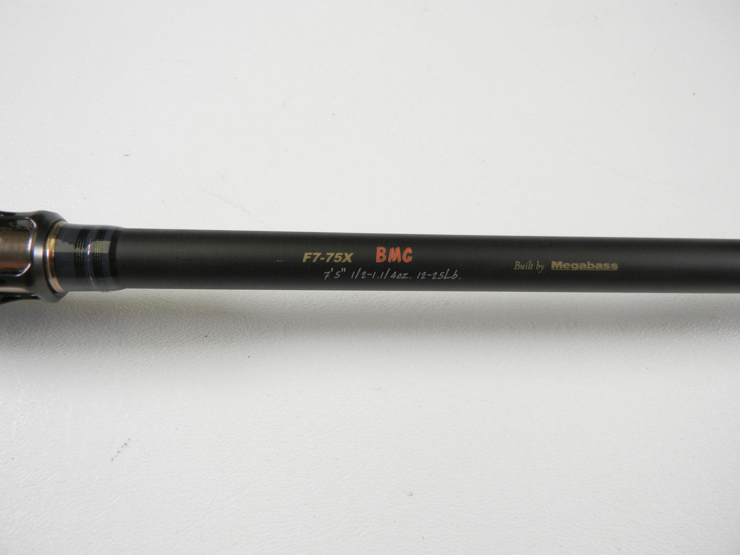 A close-up of a Megabass Destroyer P5 F7-75X BMG 7'5" Heavy Used Casting Rod in excellent condition—ideal for upgrading through our Rod and Reel Trade-In Program.