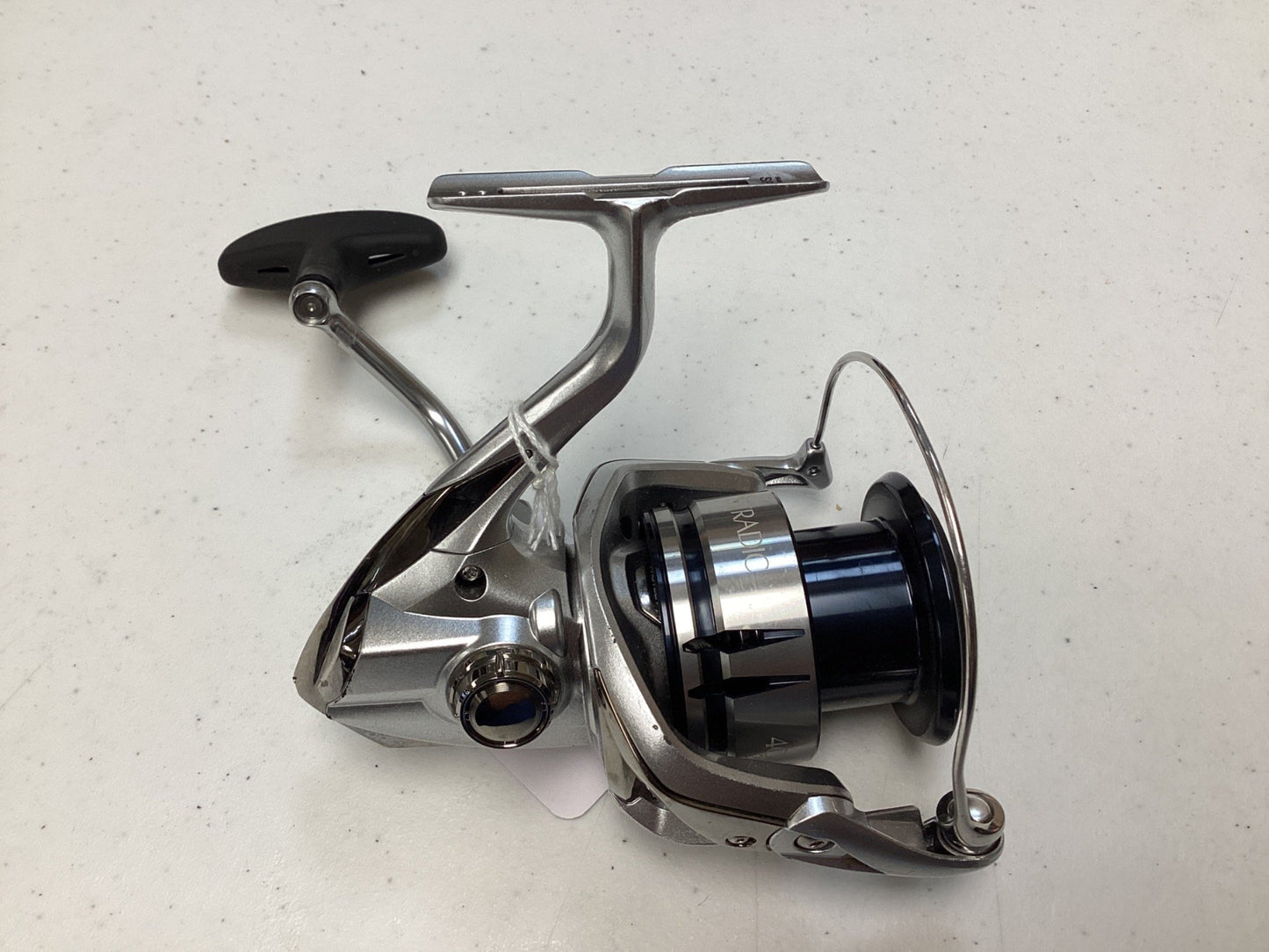 A close-up of the Shimano Stradic FL ST4000XGFL Used Spinning Reel in very good condition, highlighting its handle and spool—an ideal choice for the Rod and Reel Trade-In Program to earn store credit on your used Shimano gear.